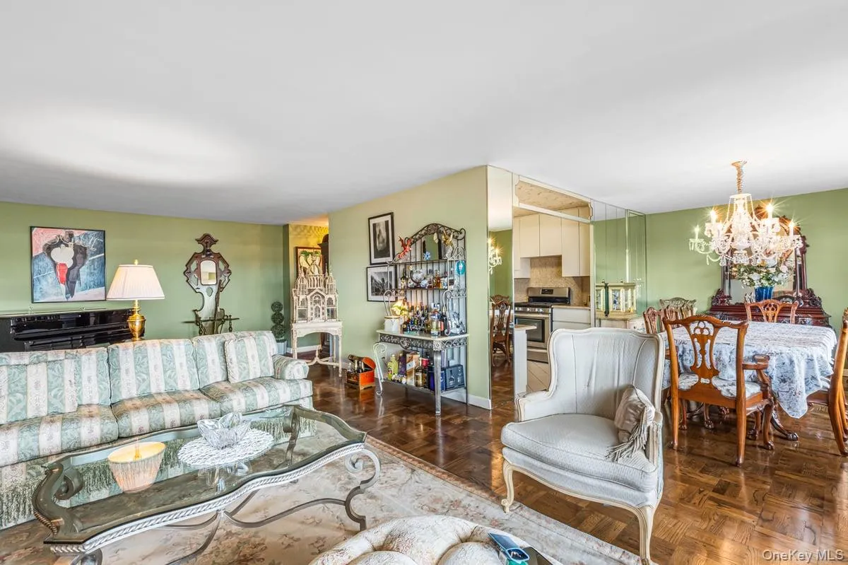 Living area with a chandelier and baseboards Living area with a chandelier and baseboards