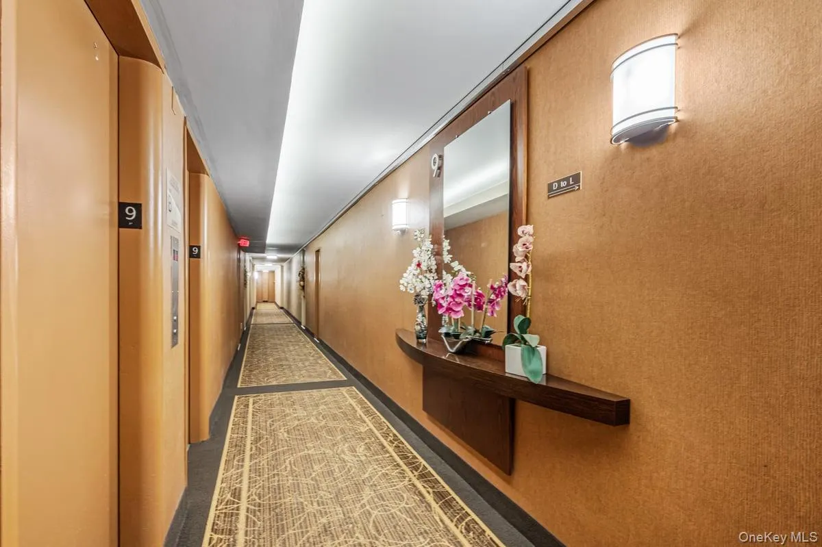 Corridor featuring dark carpet Corridor featuring dark carpet