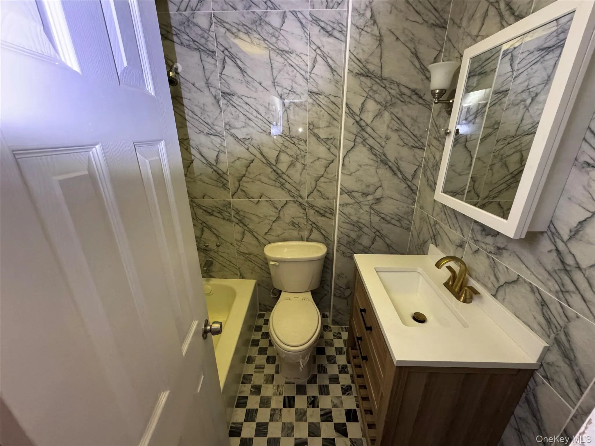 Full bathroom featuring tile walls and vanity Full bathroom featuring tile walls and vanity