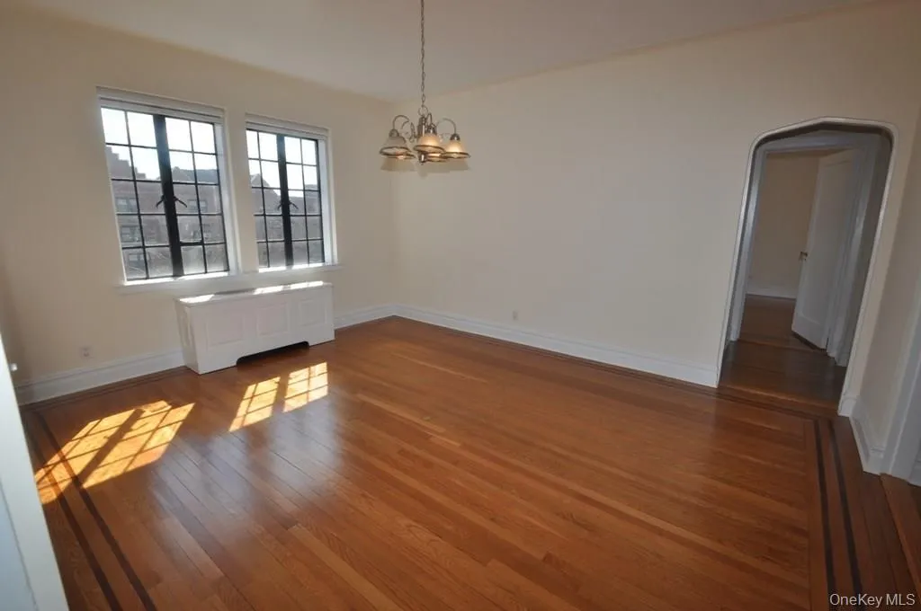 Large formal dining room has refinished hardwood floors and arched doorways leading to the large living room and butler pantry. Large formal dining room has refinished hardwood floors and arched doorways leading to the large living room and butler pantry.