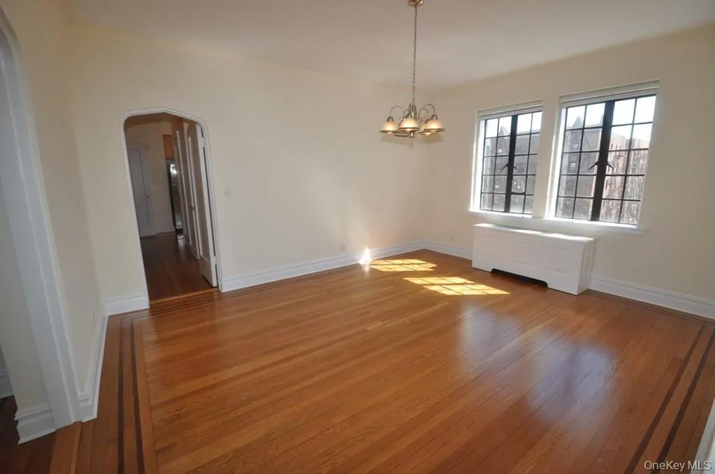 Large formal dining room has refinished hardwood floors and arched doorways leading to the large living room and butler pantry. Large formal dining room has refinished hardwood floors and arched doorways leading to the large living room and butler pantry.