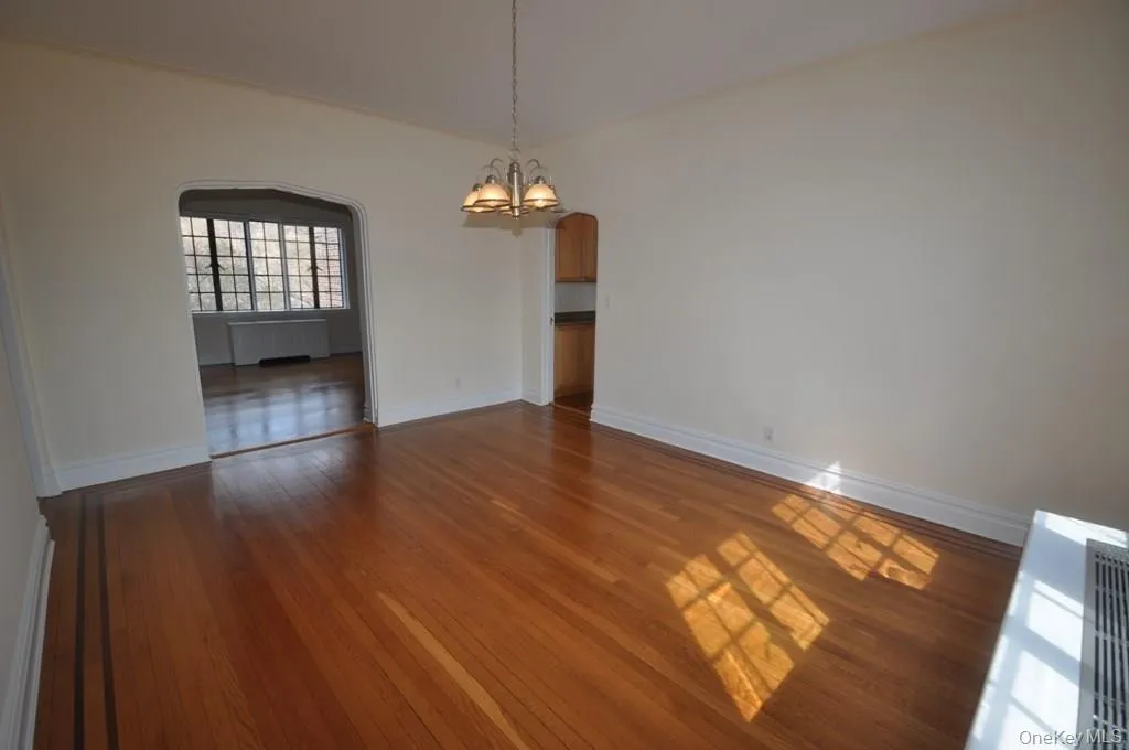 Large formal dining room has refinished hardwood floors and arched doorways leading to the large living room and butler pantry. Large formal dining room has refinished hardwood floors and arched doorways leading to the large living room and butler pantry.