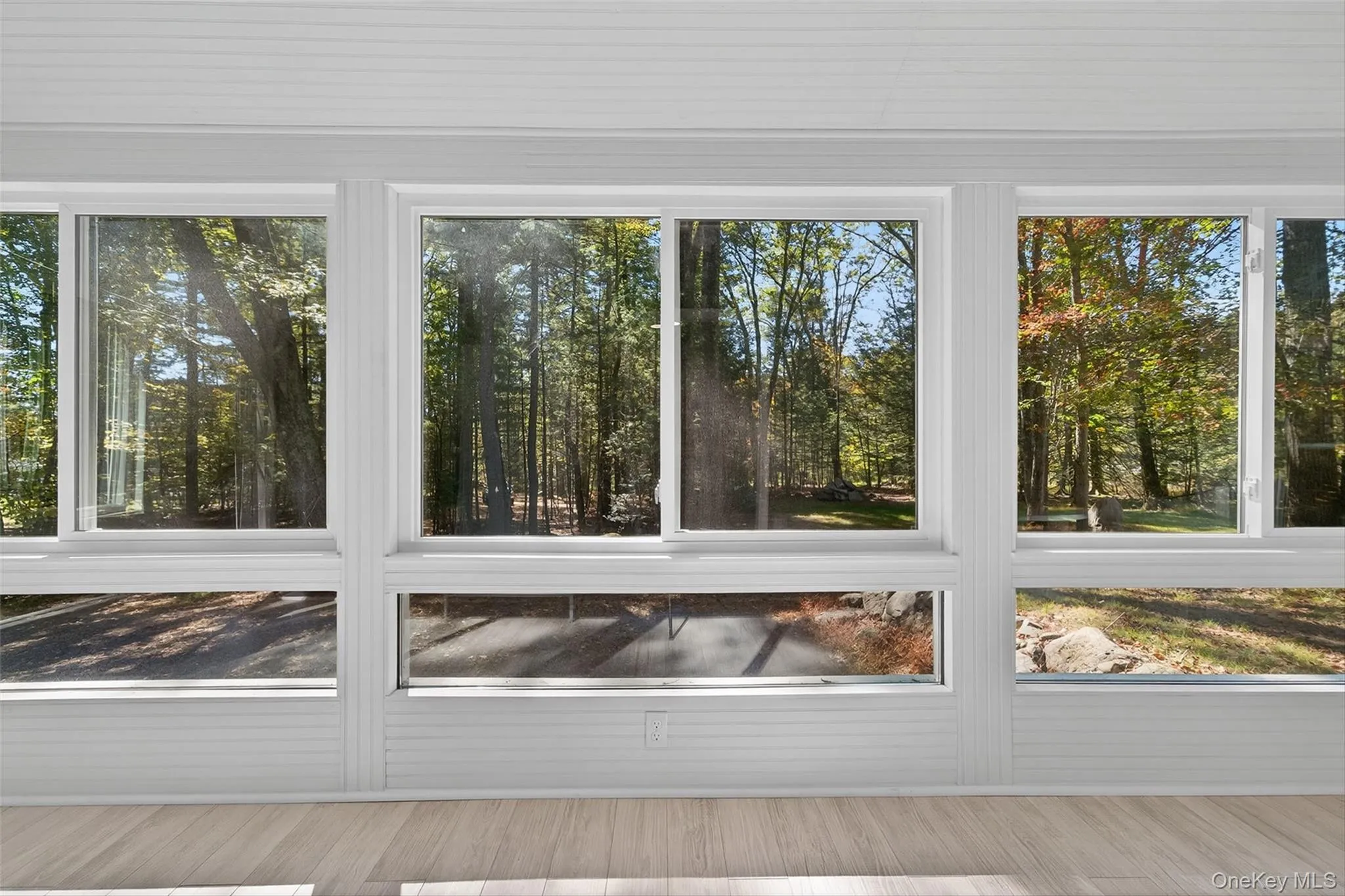 Another view of bright sunroom with lots of windows Another view of bright sunroom with lots of windows
