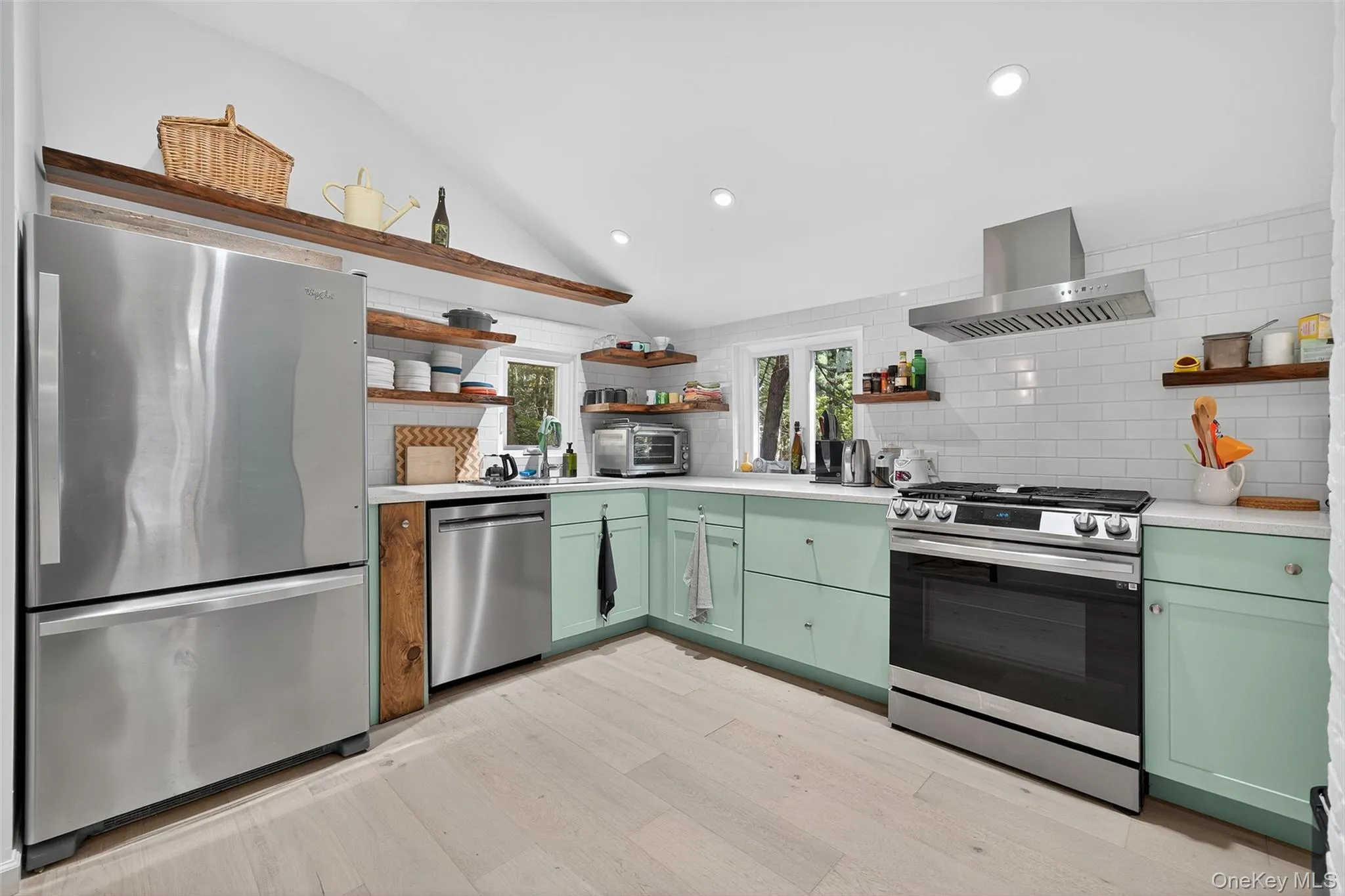 Modern kitchen with stainless appliances including refrigerator, dishwasher, and oven/range Modern kitchen with stainless appliances including refrigerator, dishwasher, and oven/range
