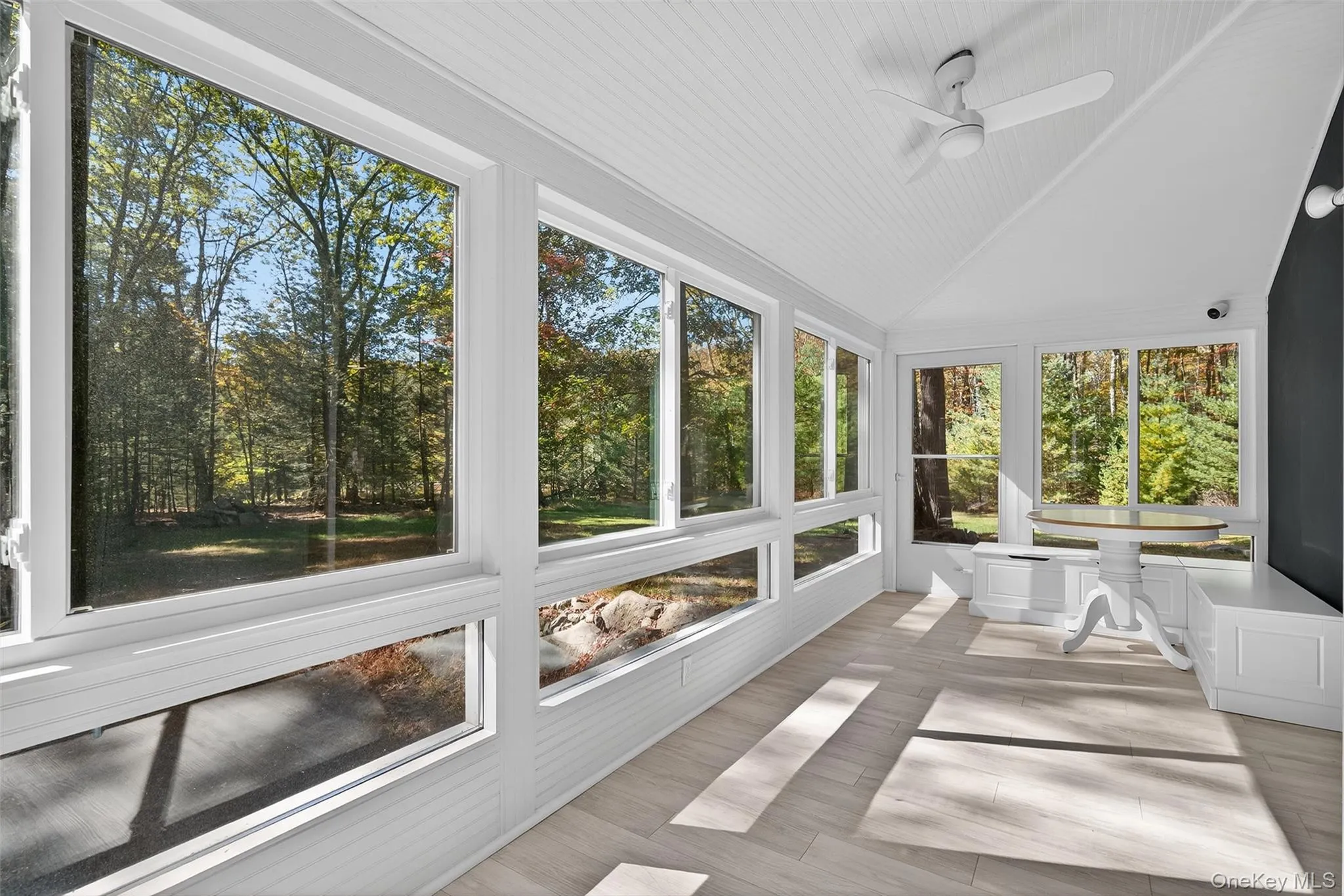 Another view of spacious sunroom with dining area Another view of spacious sunroom with dining area