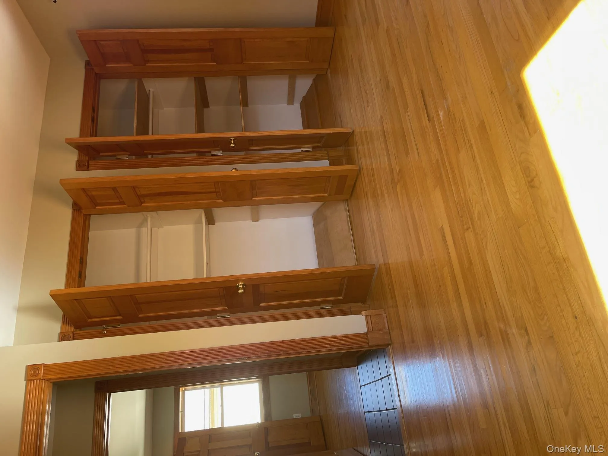 Unfurnished bedroom with light wood-style floors and two closets Unfurnished bedroom with light wood-style floors and two closets