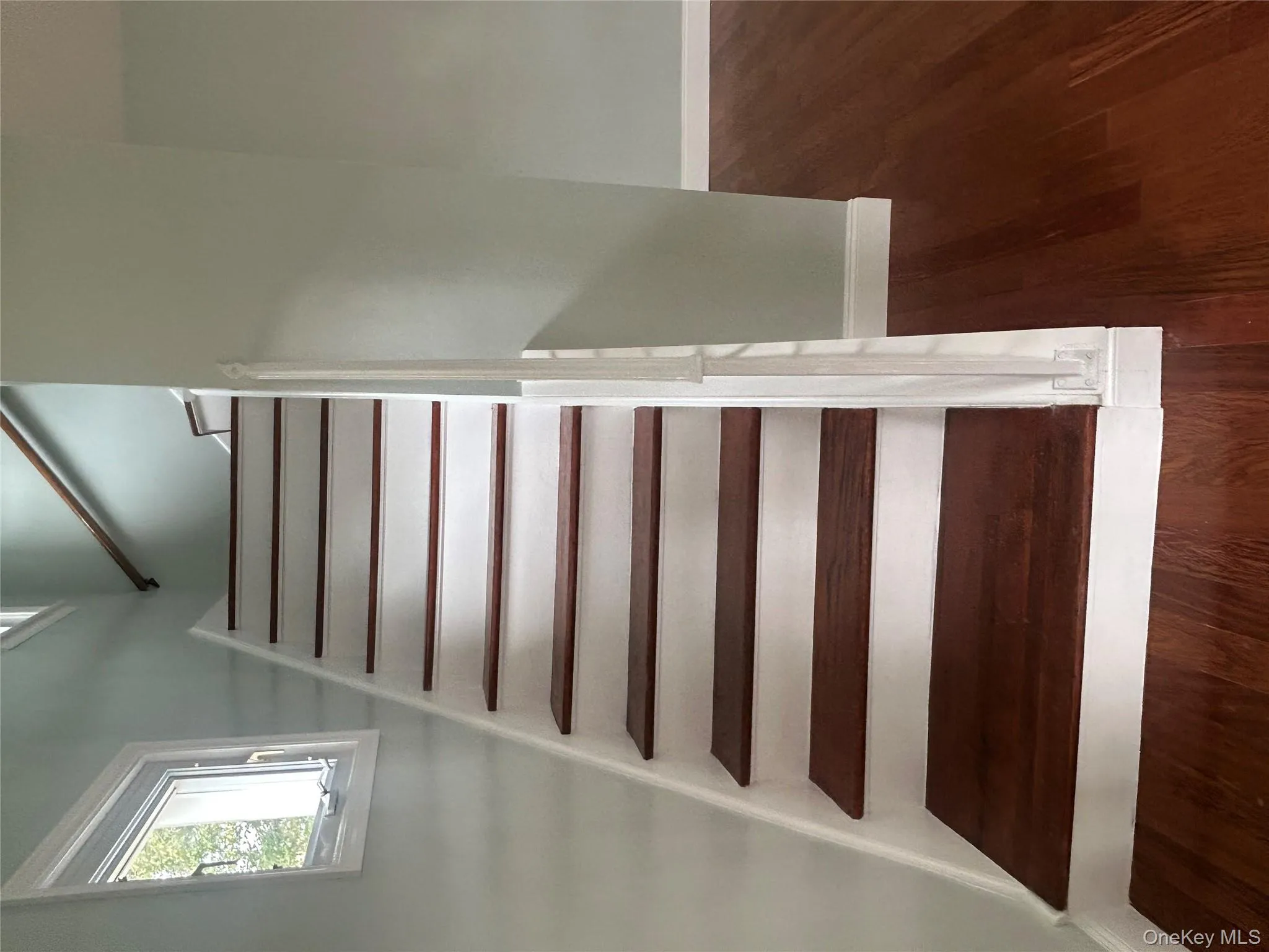 Staircase with baseboards and wood finished floors Staircase with baseboards and wood finished floors