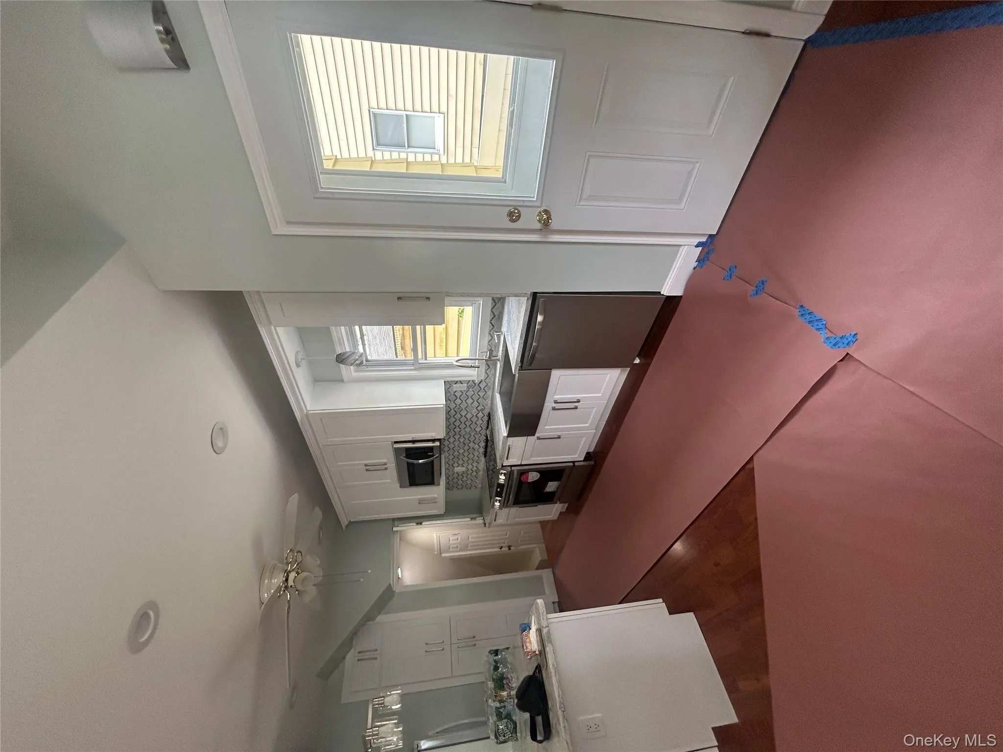 Kitchen with white cabinetry, appliances with stainless steel finishes, decorative backsplash, recessed lighting, and dark wood finished floors Kitchen with white cabinetry, appliances with stainless steel finishes, decorative backsplash, recessed lighting, and dark wood finished floors