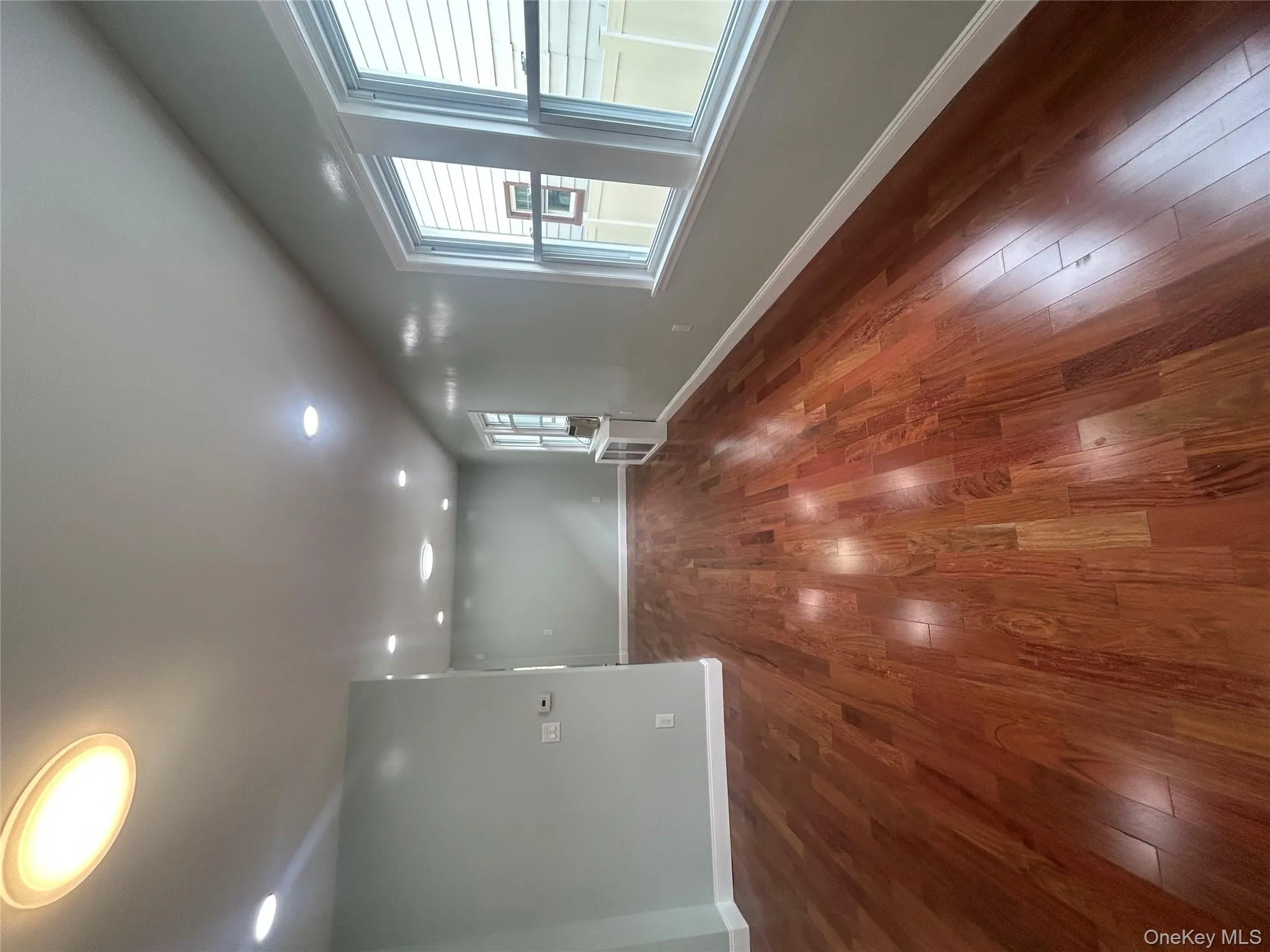 Spare room with dark wood-style flooring, recessed lighting, and radiator Spare room with dark wood-style flooring, recessed lighting, and radiator