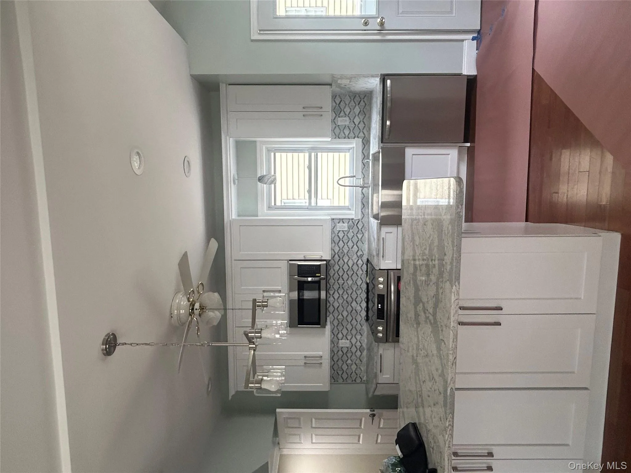 Kitchen featuring white cabinetry, light stone counters, dishwasher, range, and recessed lighting Kitchen featuring white cabinetry, light stone counters, dishwasher, range, and recessed lighting