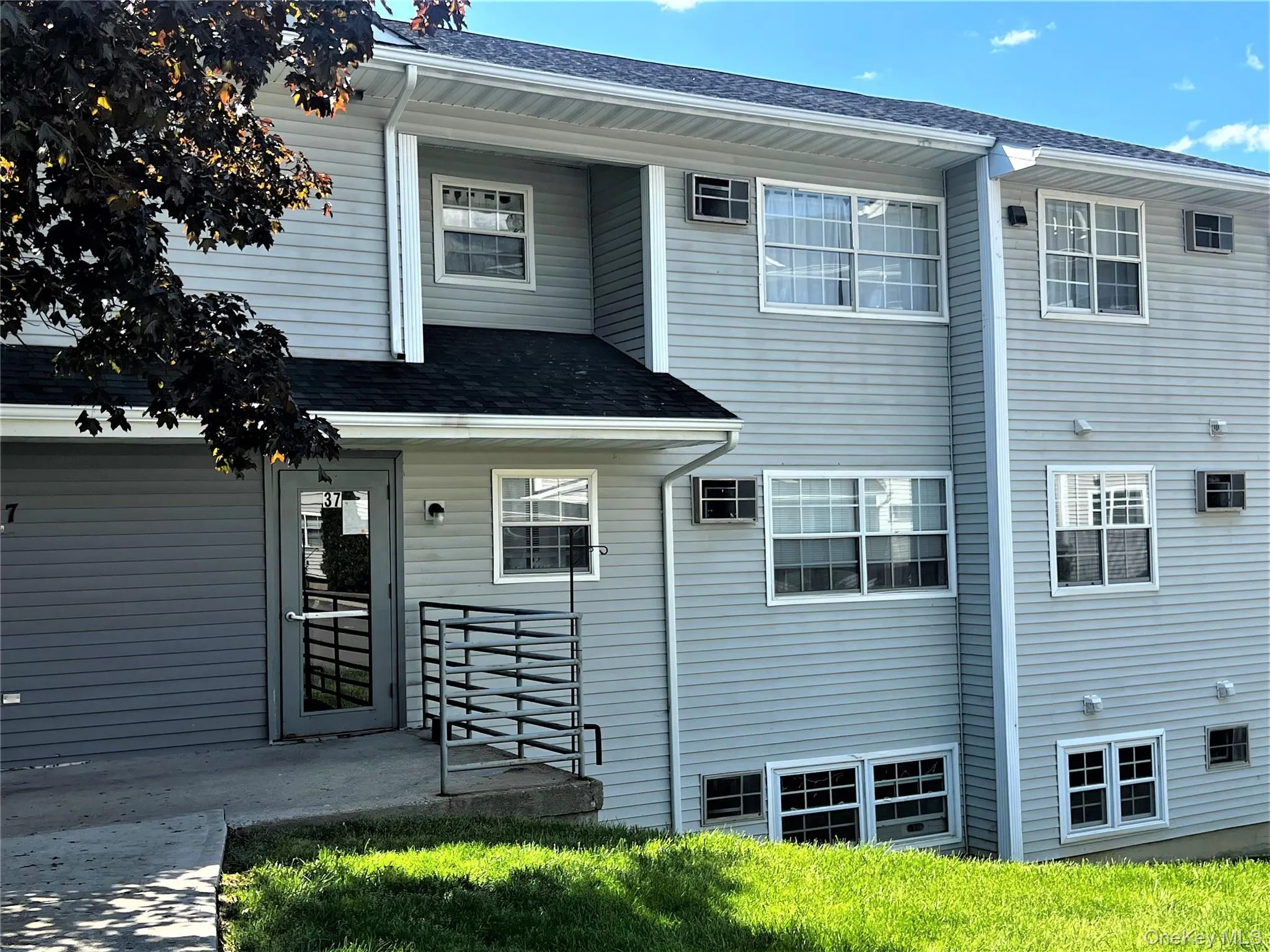 Back of property with a shingled roof Back of property with a shingled roof