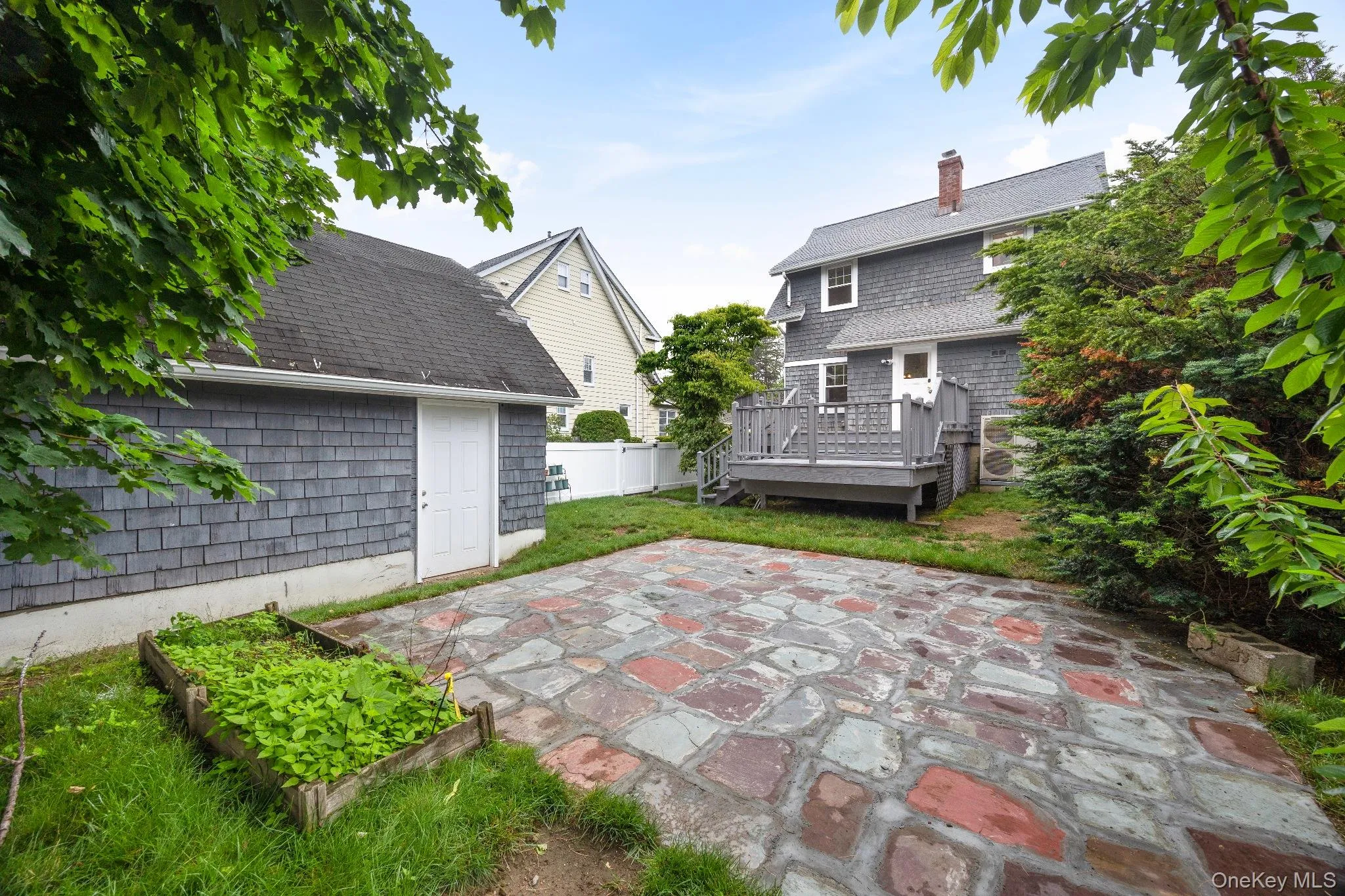View of patio / terrace featuring a deck and a vegetable garden View of patio / terrace featuring a deck and a vegetable garden