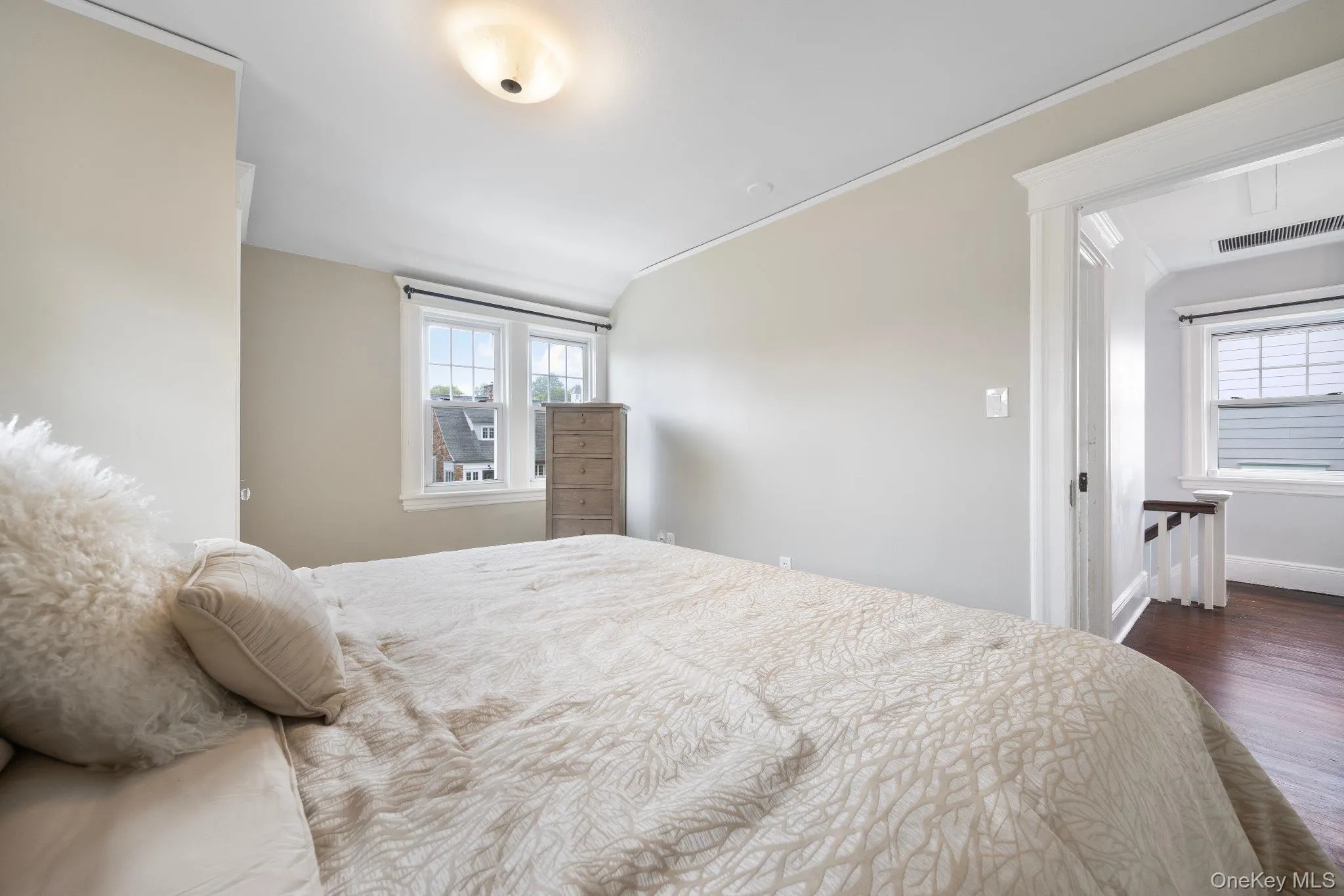 Bedroom featuring dark wood finished floors and baseboards Bedroom featuring dark wood finished floors and baseboards