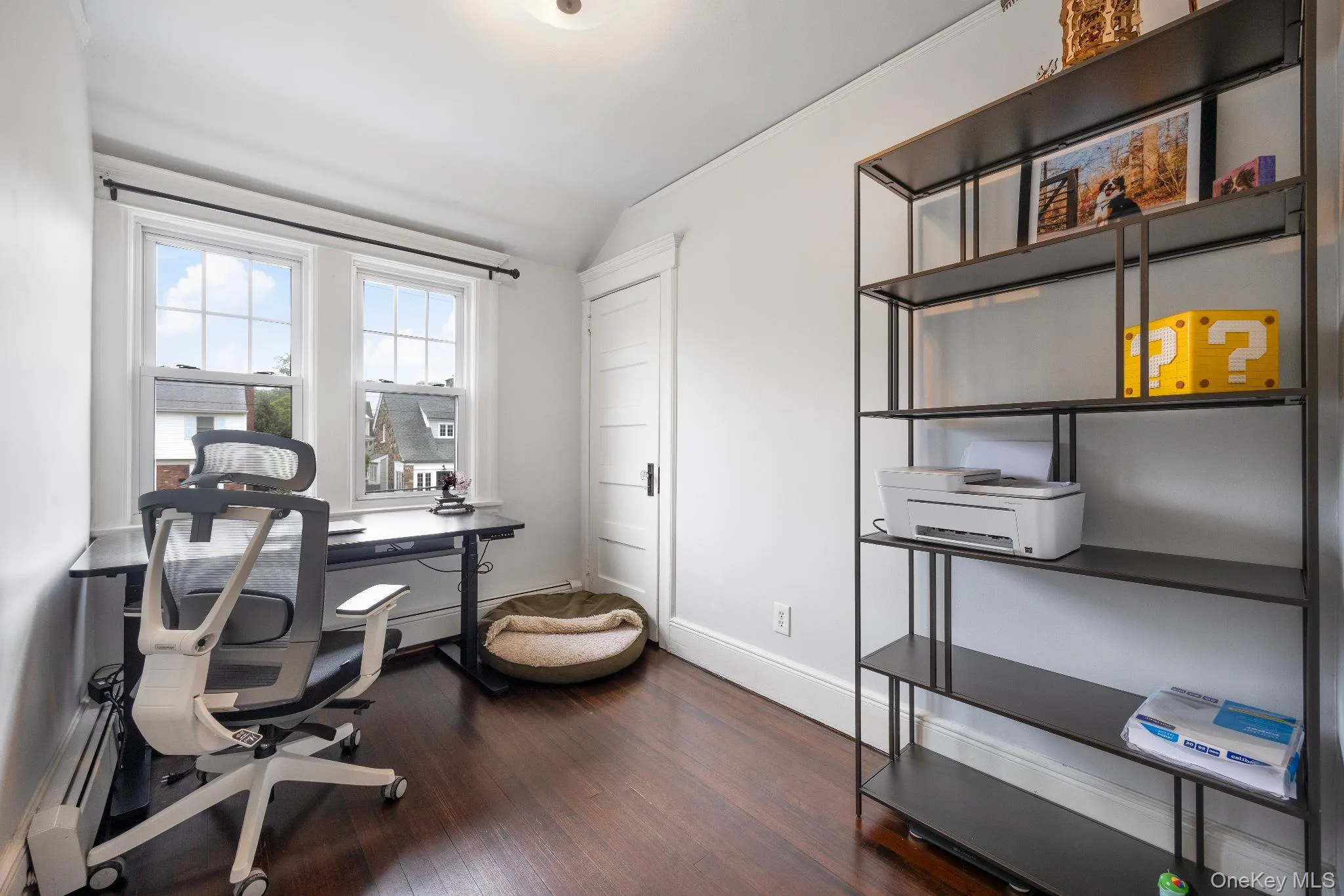 Home office with dark wood-style floors, baseboard heating, and lofted ceiling Home office with dark wood-style floors, baseboard heating, and lofted ceiling