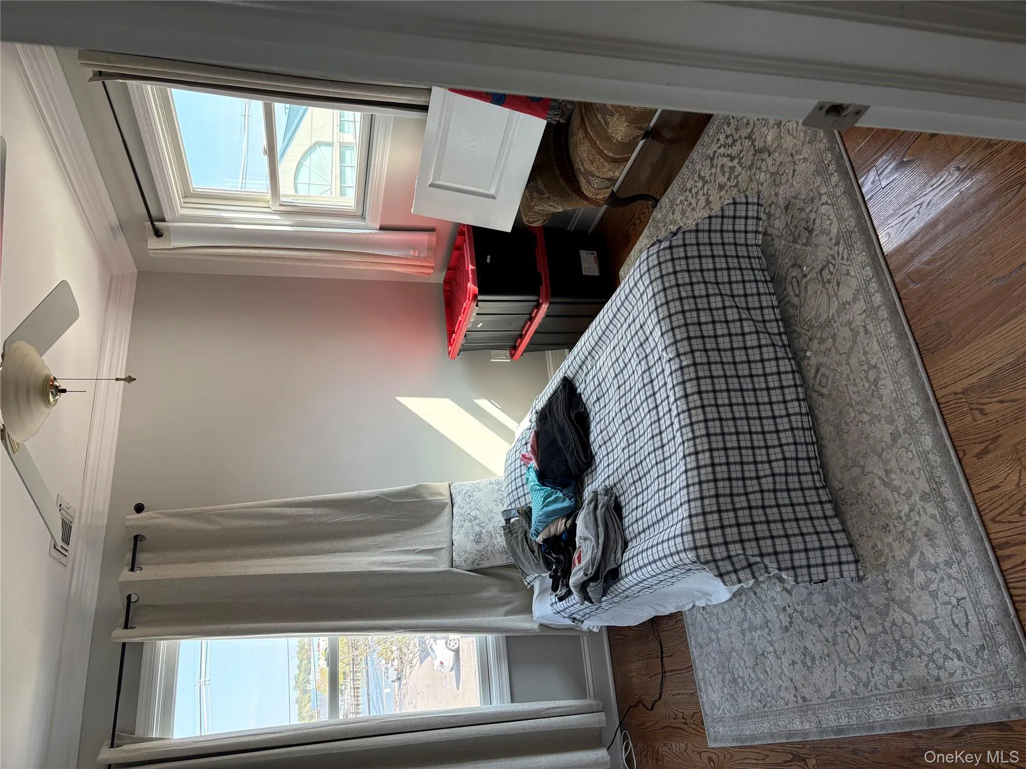 Bedroom with ornamental molding, dark hardwood floors, and ceiling fan Bedroom with ornamental molding, dark hardwood floors, and ceiling fan