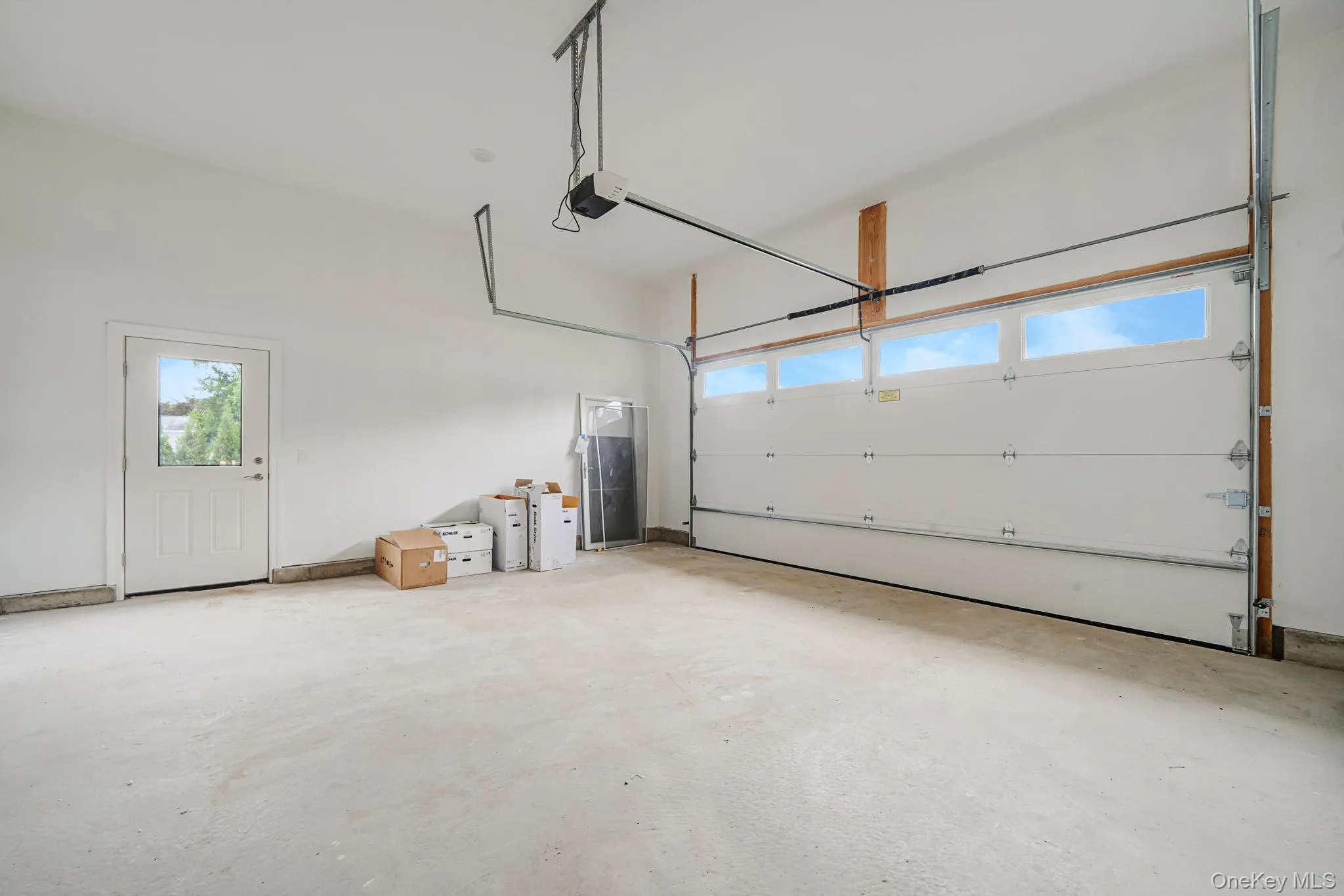 Garage featuring a garage door opener Garage featuring a garage door opener
