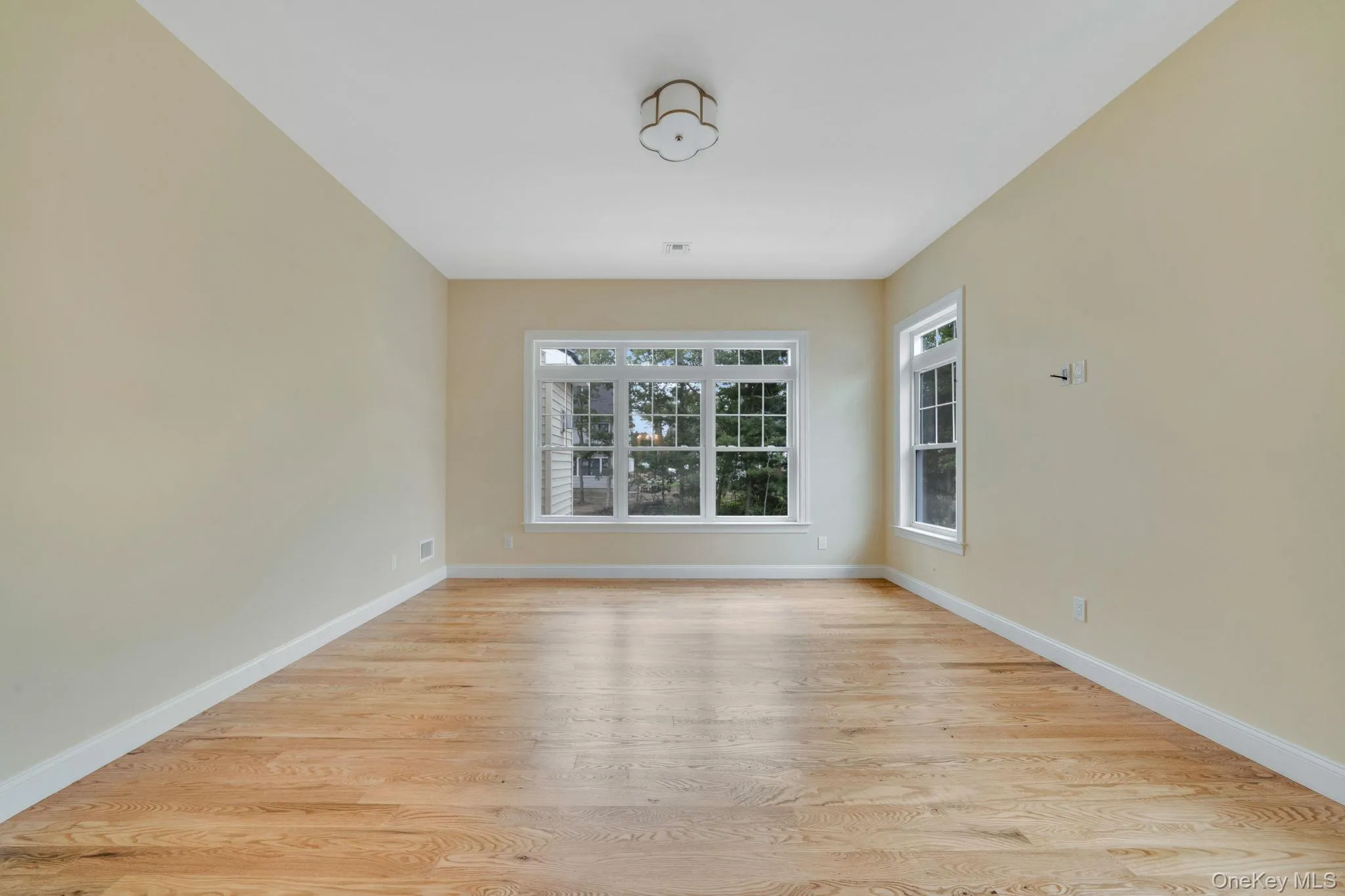 Spare room featuring light wood-style flooring Spare room featuring light wood-style flooring