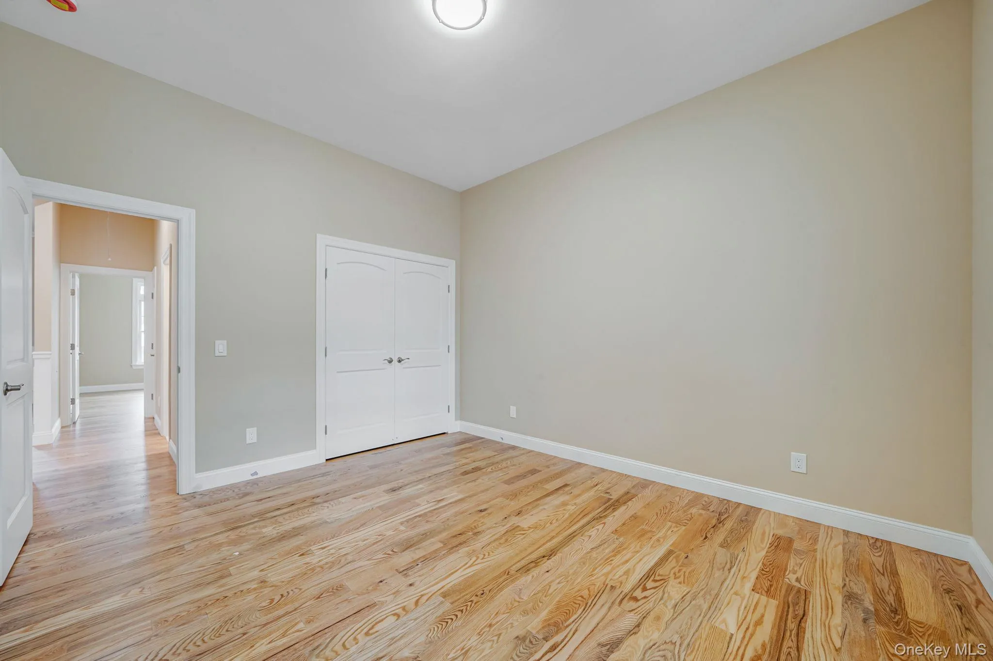 Unfurnished bedroom with light wood-style flooring and a closet Unfurnished bedroom with light wood-style flooring and a closet