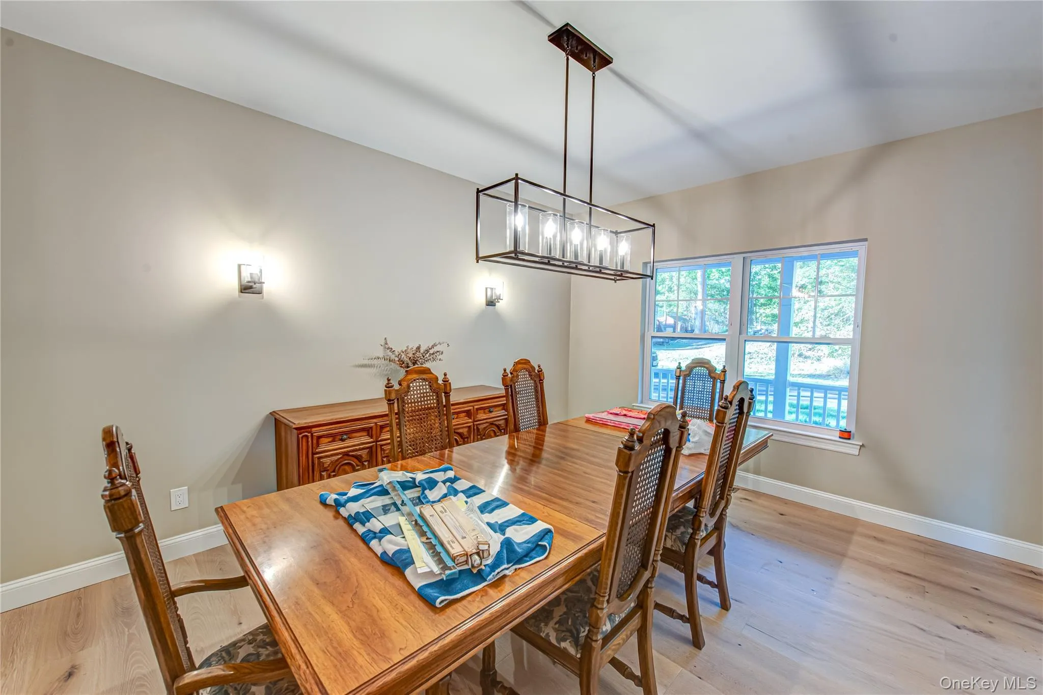 Dining area with light wood finished floors and a chandelier Dining area with light wood finished floors and a chandelier