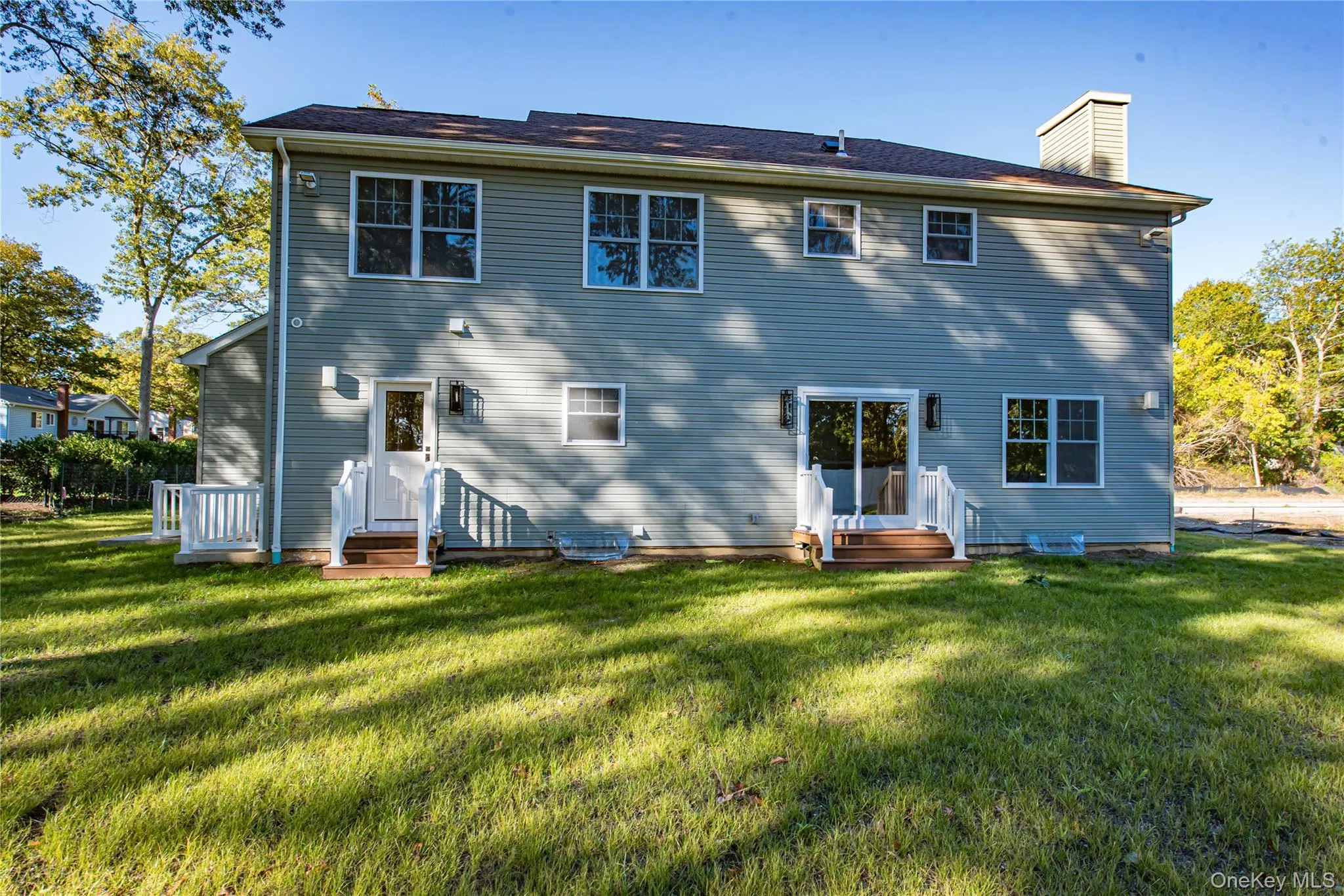 Rear view of property with a lawn and a chimney Rear view of property with a lawn and a chimney