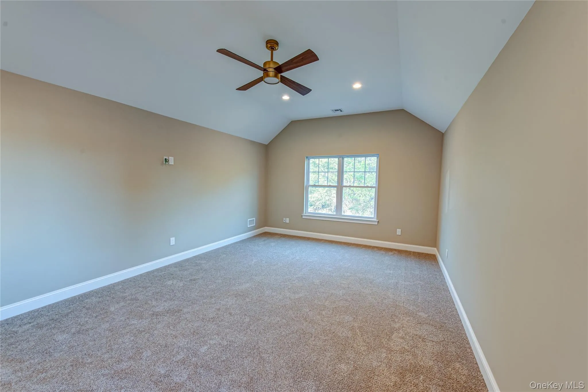 Empty room with vaulted ceiling, light colored carpet, ceiling fan, and recessed lighting Empty room with vaulted ceiling, light colored carpet, ceiling fan, and recessed lighting