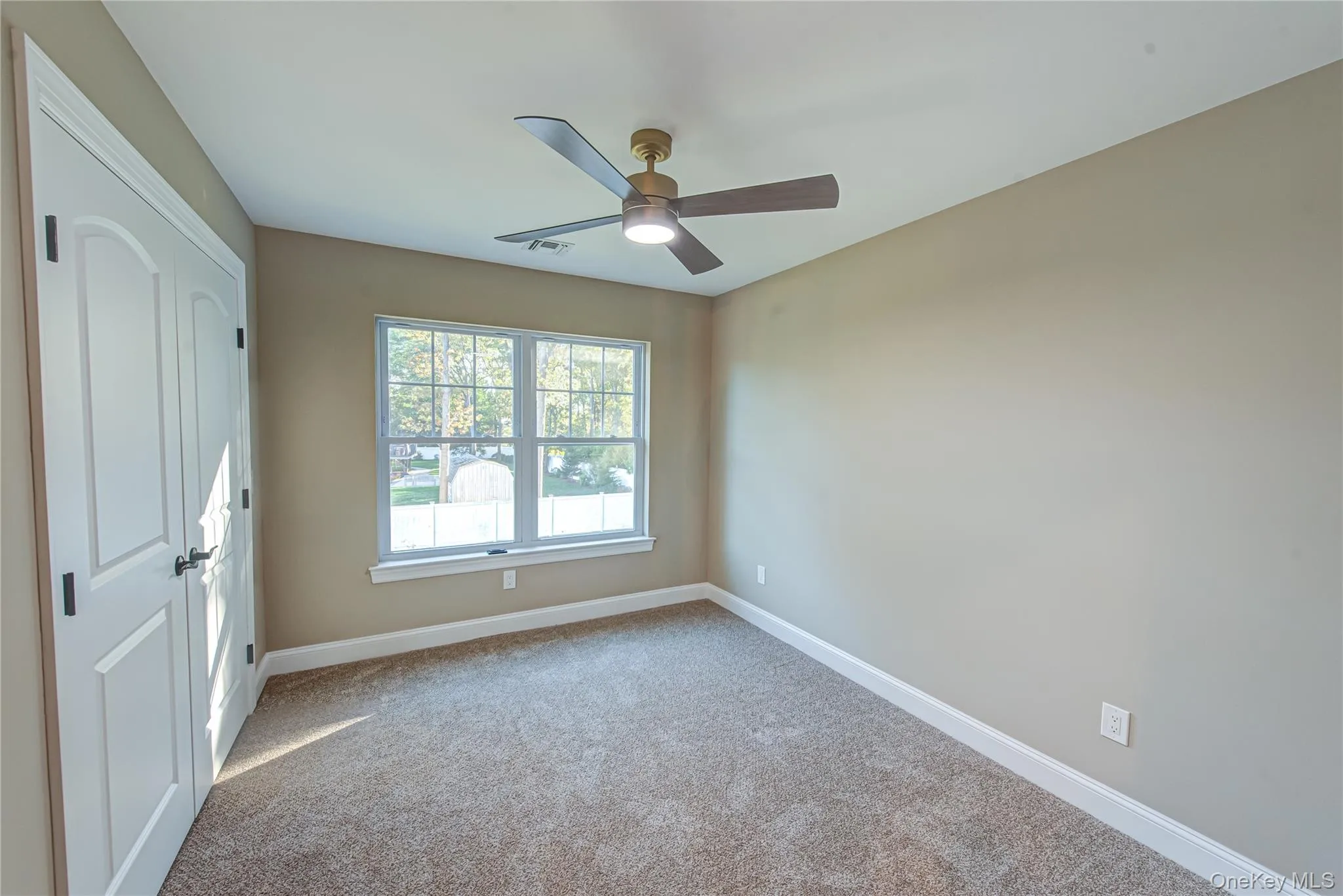 Unfurnished room featuring carpet floors and a ceiling fan Unfurnished room featuring carpet floors and a ceiling fan