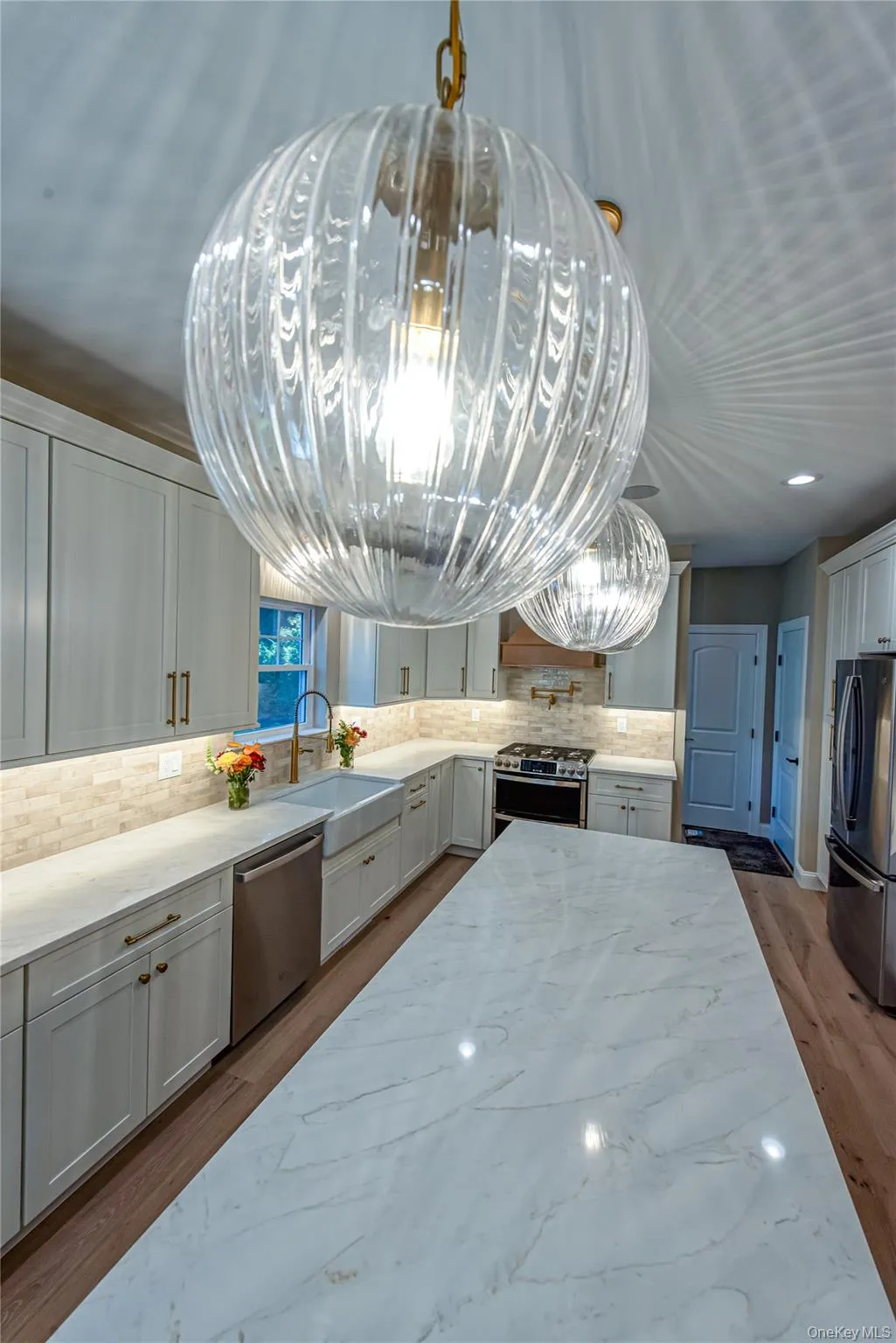 Kitchen featuring light stone counters, tasteful backsplash, white cabinets, stainless steel appliances, and recessed lighting Kitchen featuring light stone counters, tasteful backsplash, white cabinets, stainless steel appliances, and recessed lighting