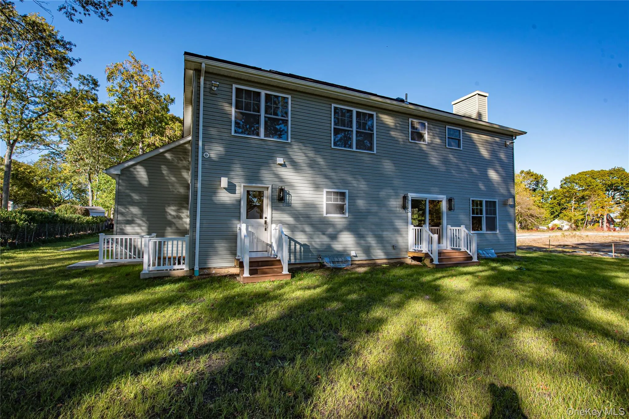 Rear view of property featuring a chimney Rear view of property featuring a chimney