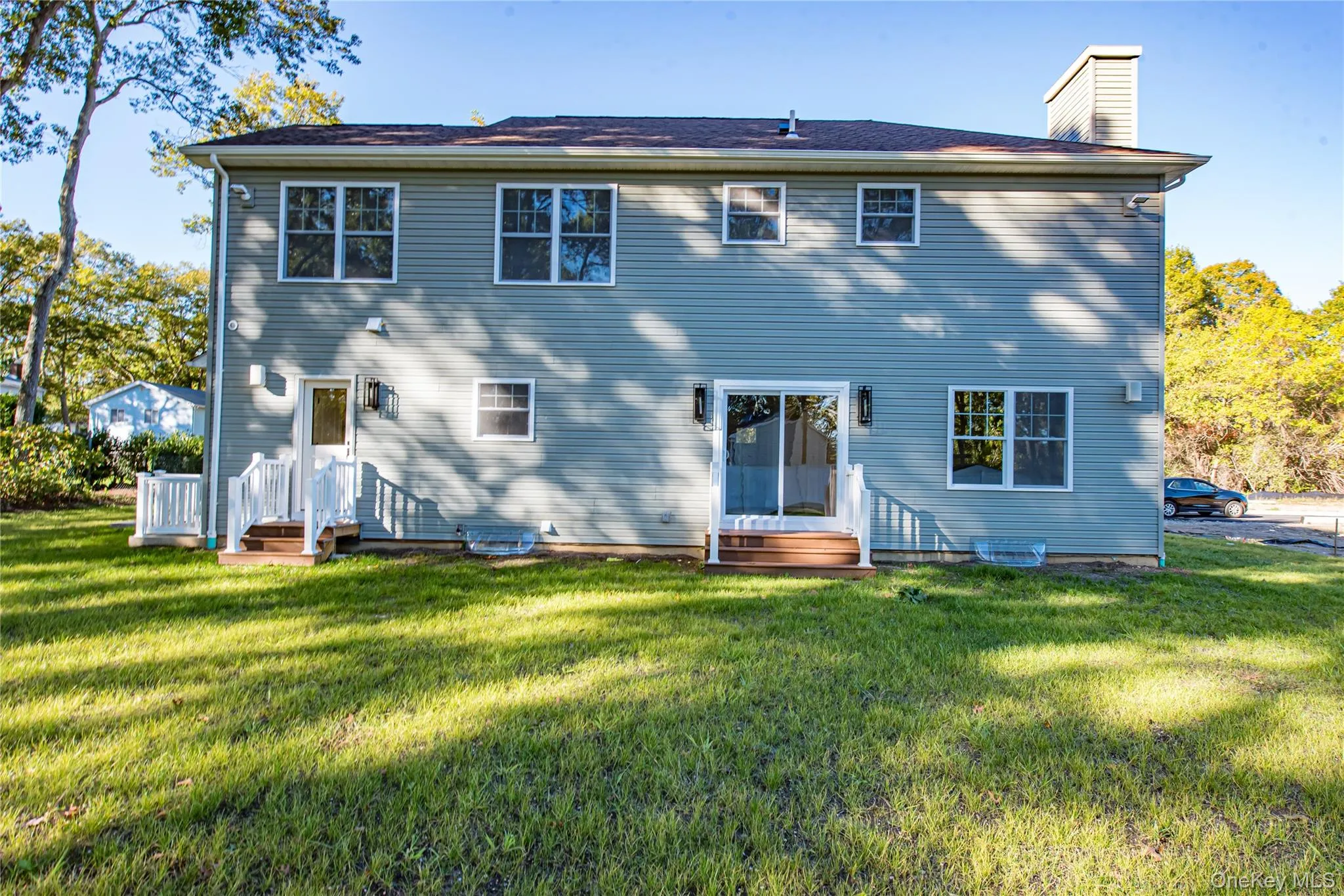 Back of property with a yard and a chimney Back of property with a yard and a chimney