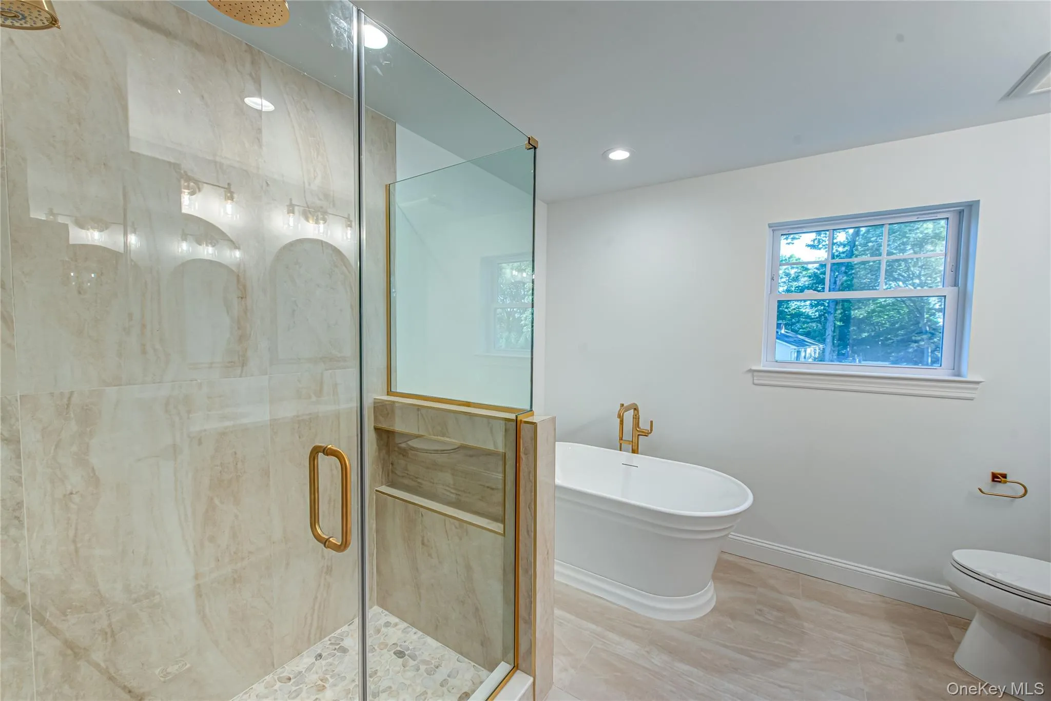 Full bathroom featuring a shower stall, a freestanding tub, and recessed lighting Full bathroom featuring a shower stall, a freestanding tub, and recessed lighting