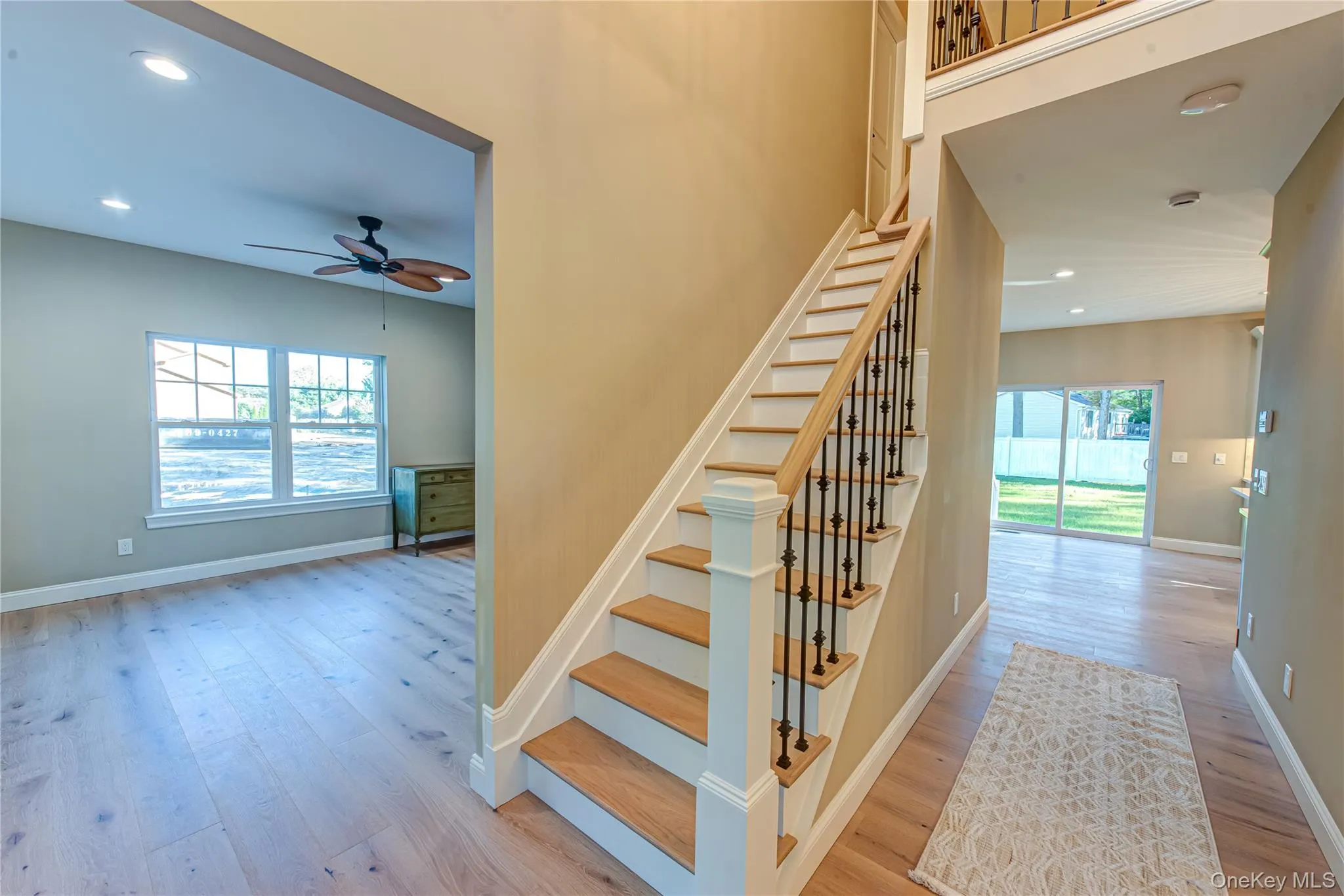 Stairs featuring recessed lighting, wood finished floors, a ceiling fan, and plenty of natural light Stairs featuring recessed lighting, wood finished floors, a ceiling fan, and plenty of natural light