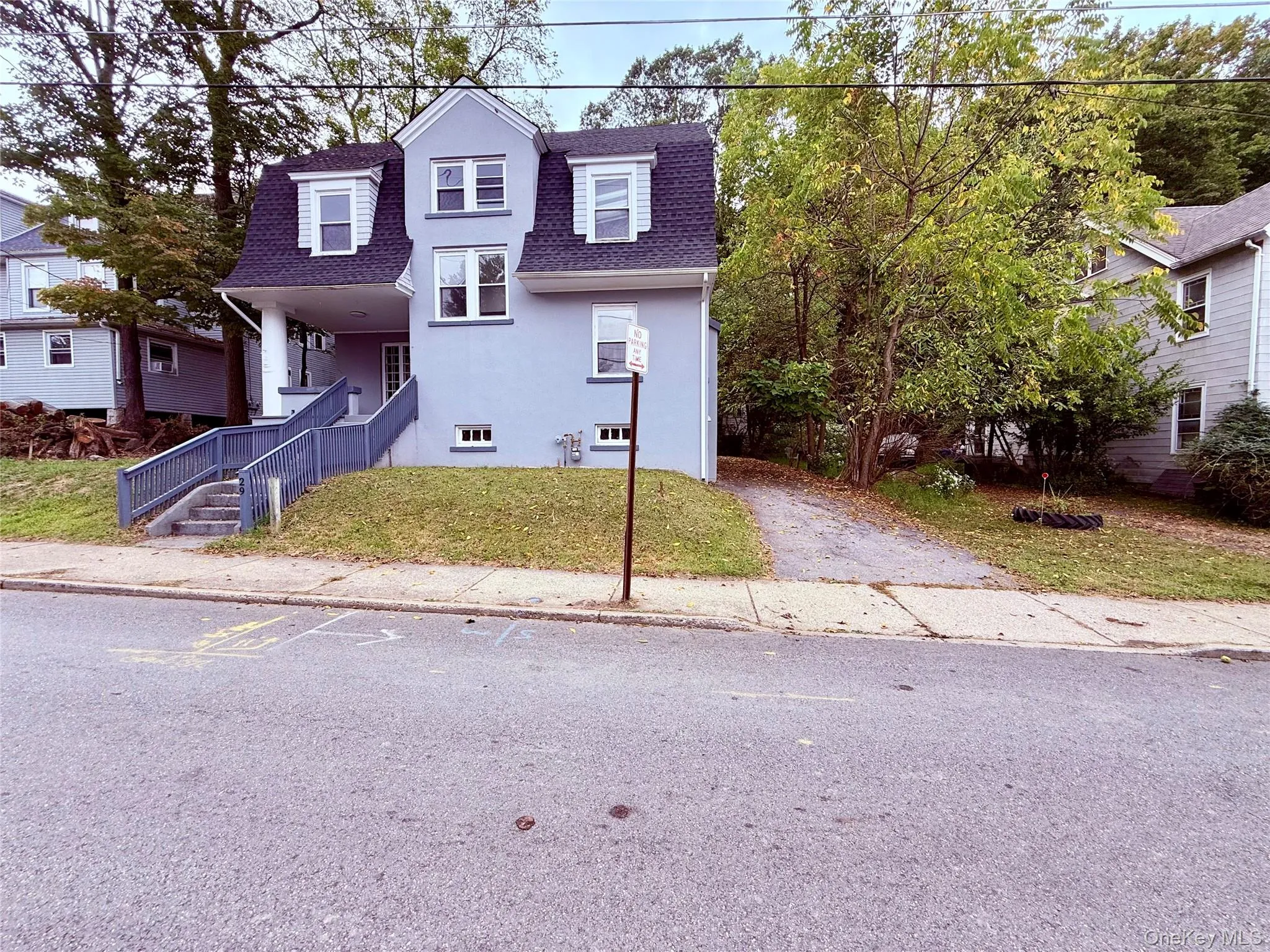 View of front of home with a shingled roof, a front yard, and a porch View of front of home with a shingled roof, a front yard, and a porch