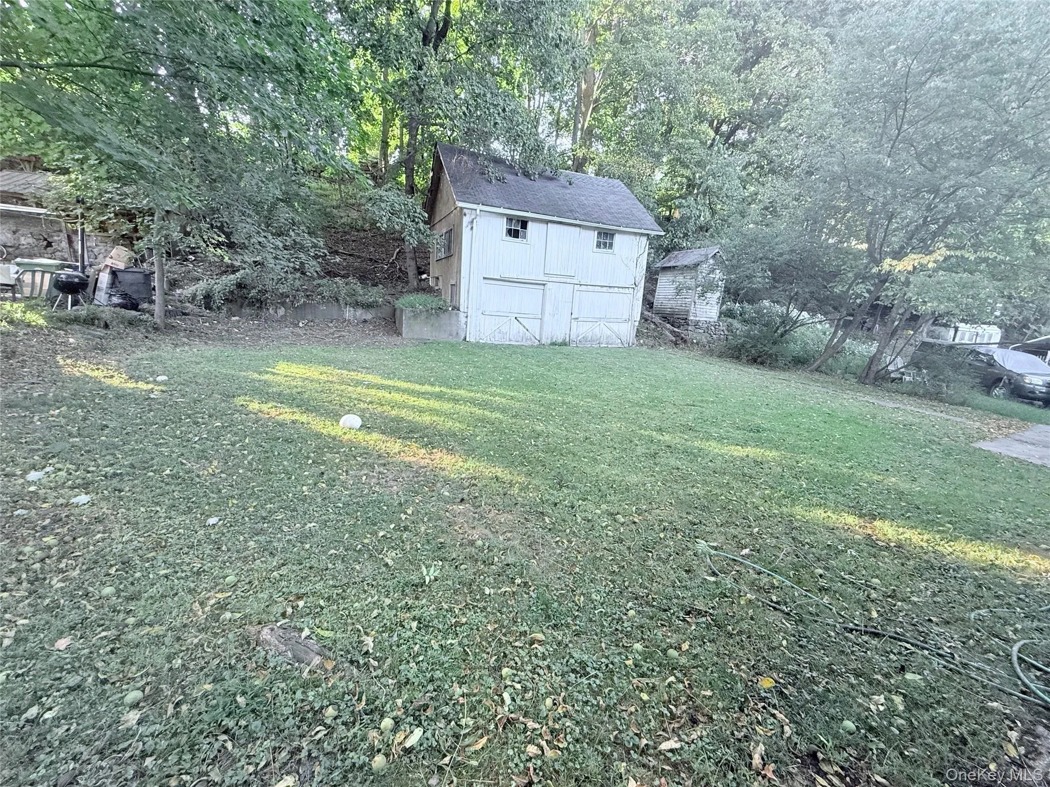 View of green lawn featuring a shed View of green lawn featuring a shed