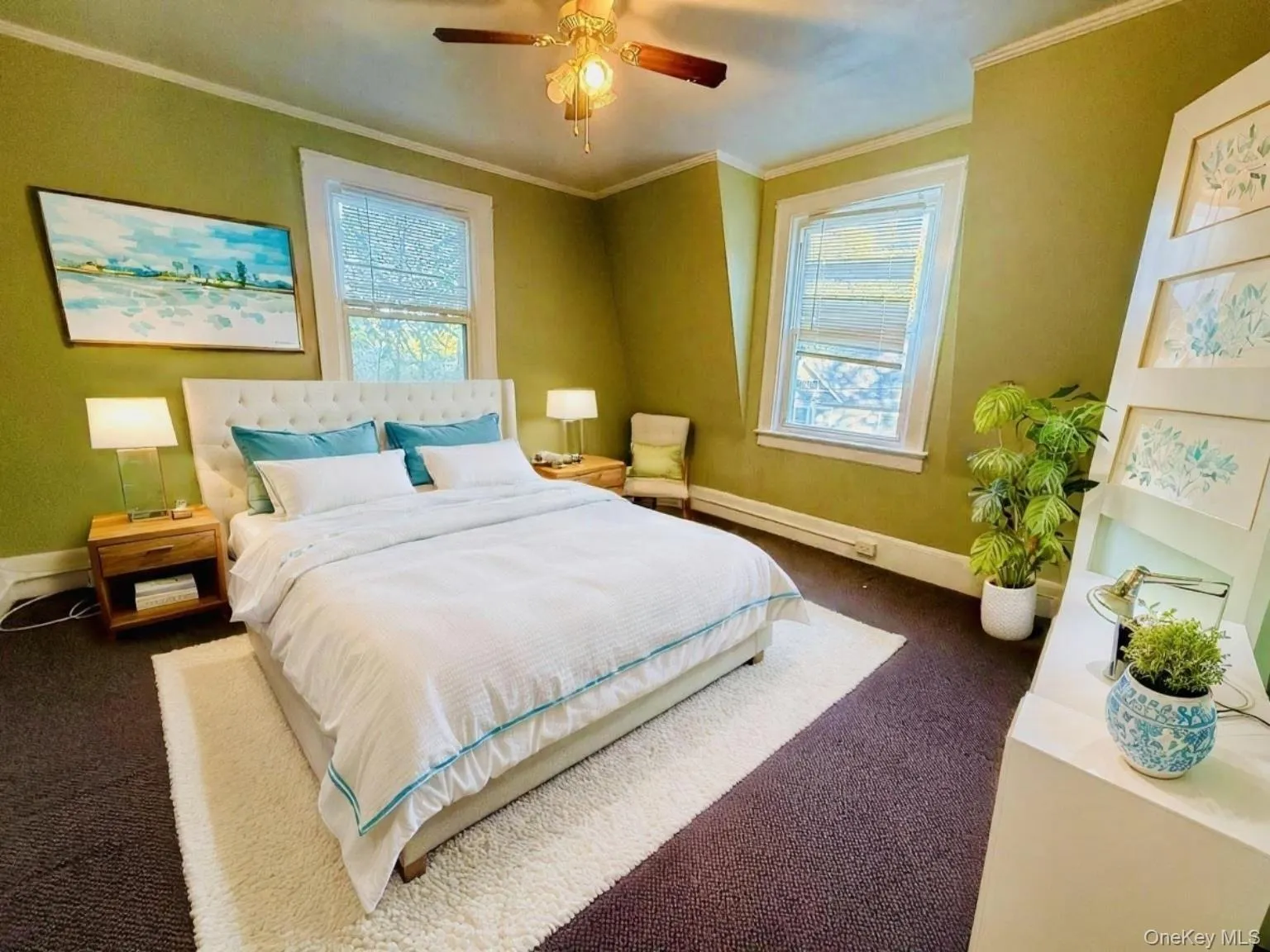 Carpeted bedroom featuring ornamental molding and a ceiling fan Carpeted bedroom featuring ornamental molding and a ceiling fan