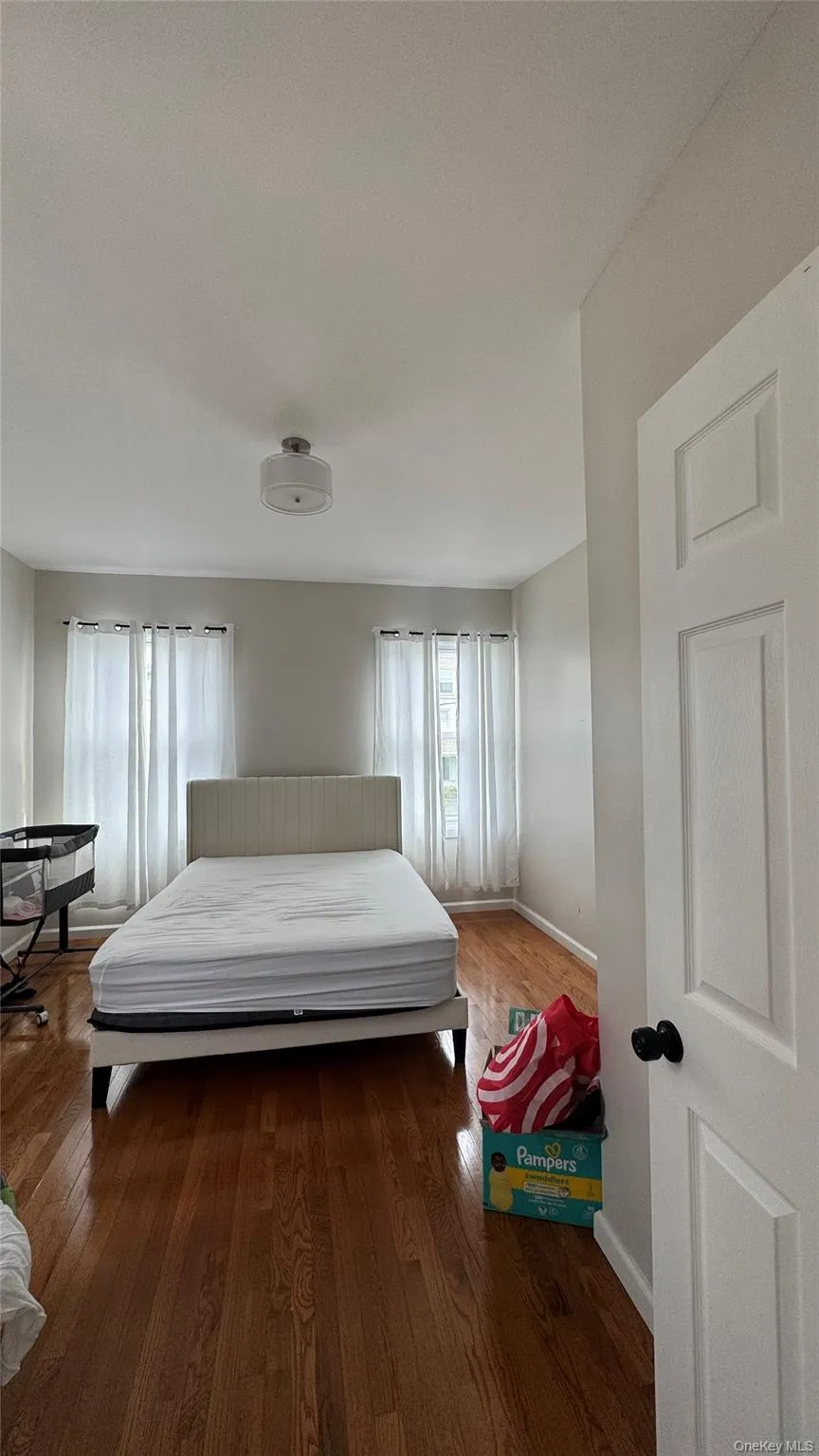 Bedroom with wood-type flooring and baseboards Bedroom with wood-type flooring and baseboards