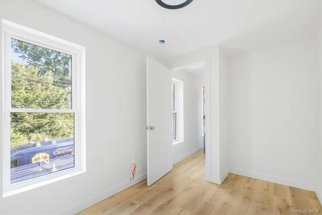 Bedroom featuring plenty of natural light and light wood-type flooring Bedroom featuring plenty of natural light and light wood-type flooring