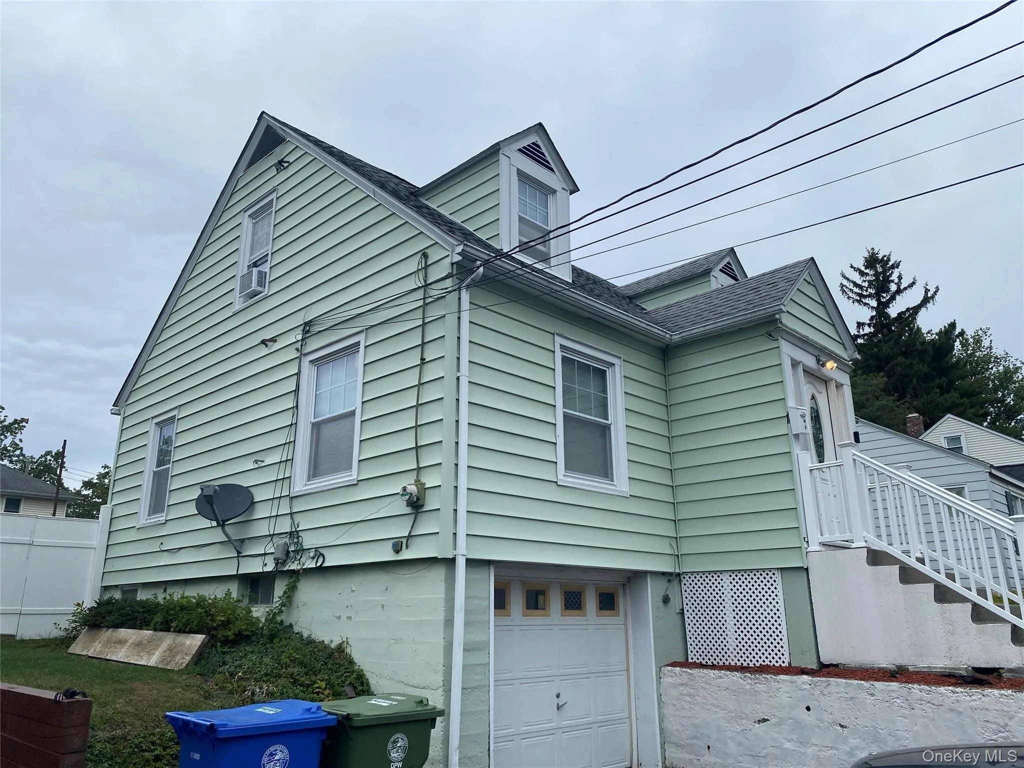View of home's exterior with an attached garage and roof with shingles View of home's exterior with an attached garage and roof with shingles