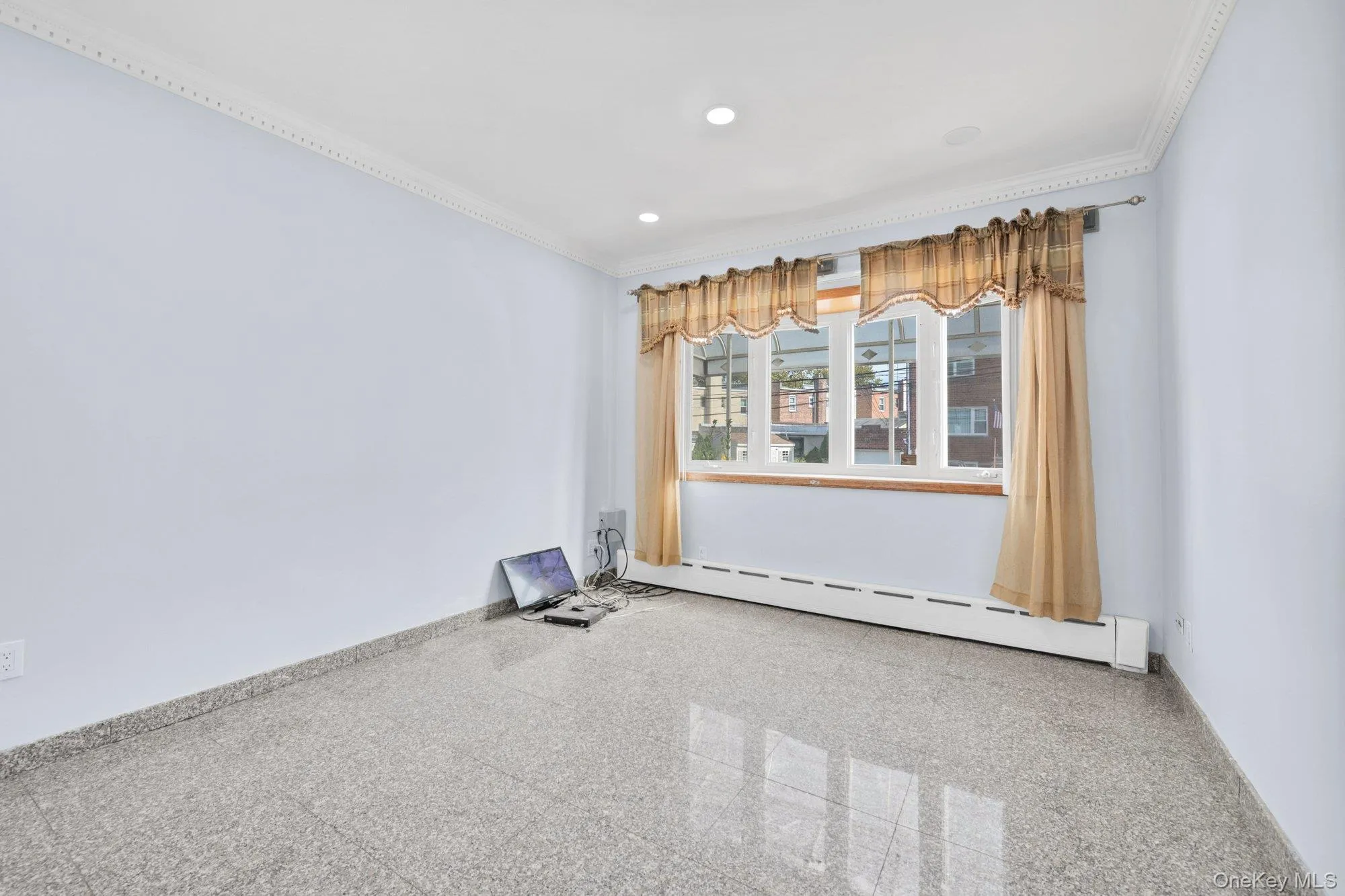 Spare room featuring crown molding, a baseboard radiator, and recessed lighting Spare room featuring crown molding, a baseboard radiator, and recessed lighting