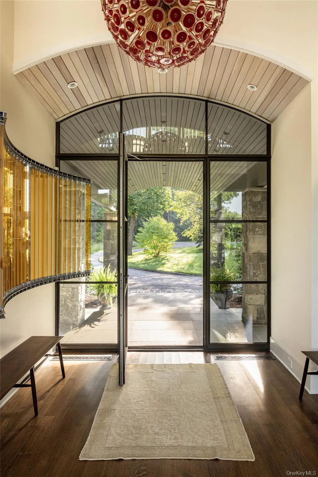 Entryway featuring healthy amount of natural light and hardwood / wood-style flooring Entryway featuring healthy amount of natural light and hardwood / wood-style flooring
