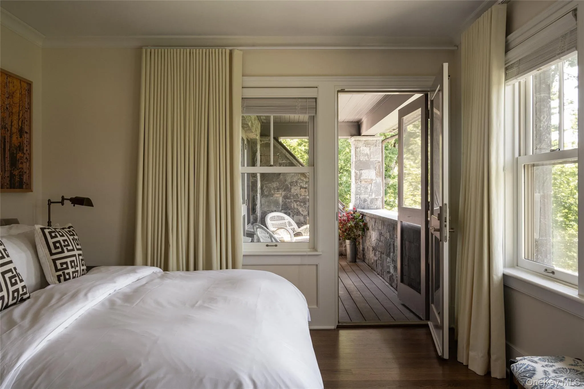 Bedroom featuring dark wood-style flooring and crown molding Bedroom featuring dark wood-style flooring and crown molding