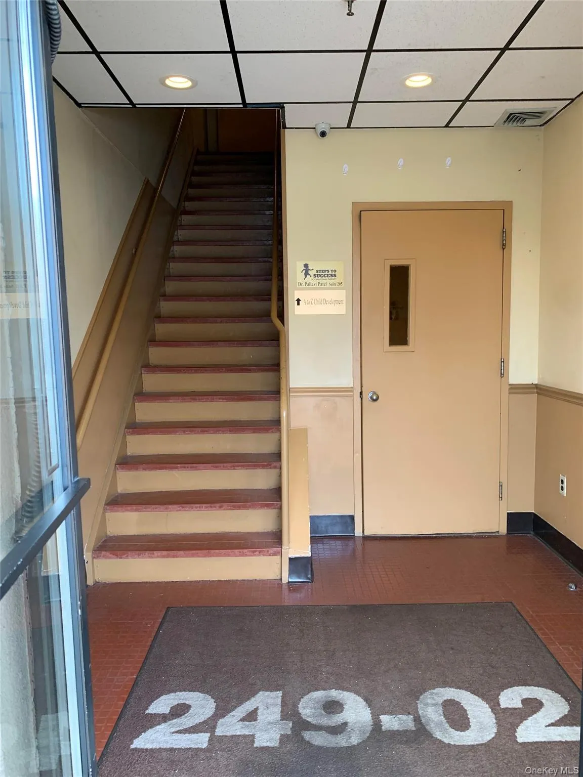Stairs with a drop ceiling, elevator, and recessed lighting Stairs with a drop ceiling, elevator, and recessed lighting