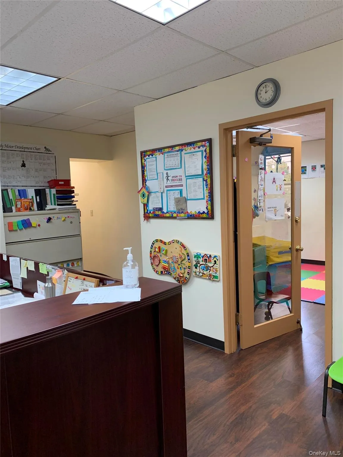 Office featuring dark wood-style flooring and a paneled ceiling Office featuring dark wood-style flooring and a paneled ceiling
