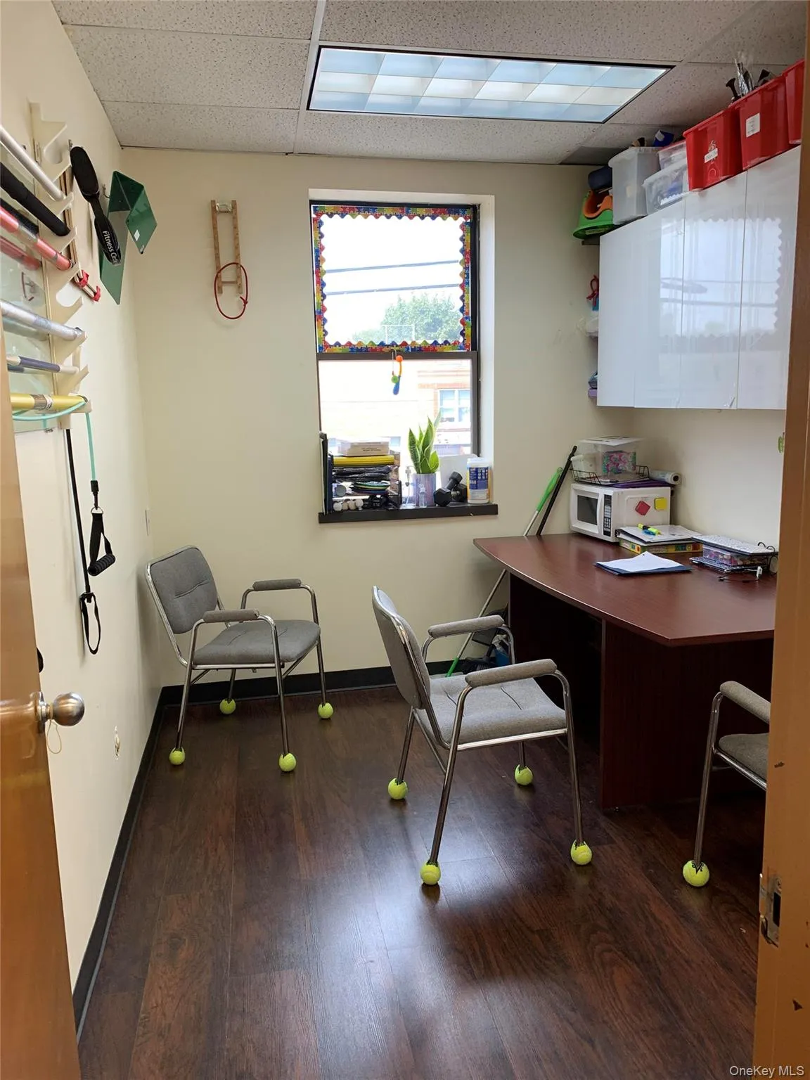 Home office featuring a drop ceiling and dark wood-style flooring Home office featuring a drop ceiling and dark wood-style flooring