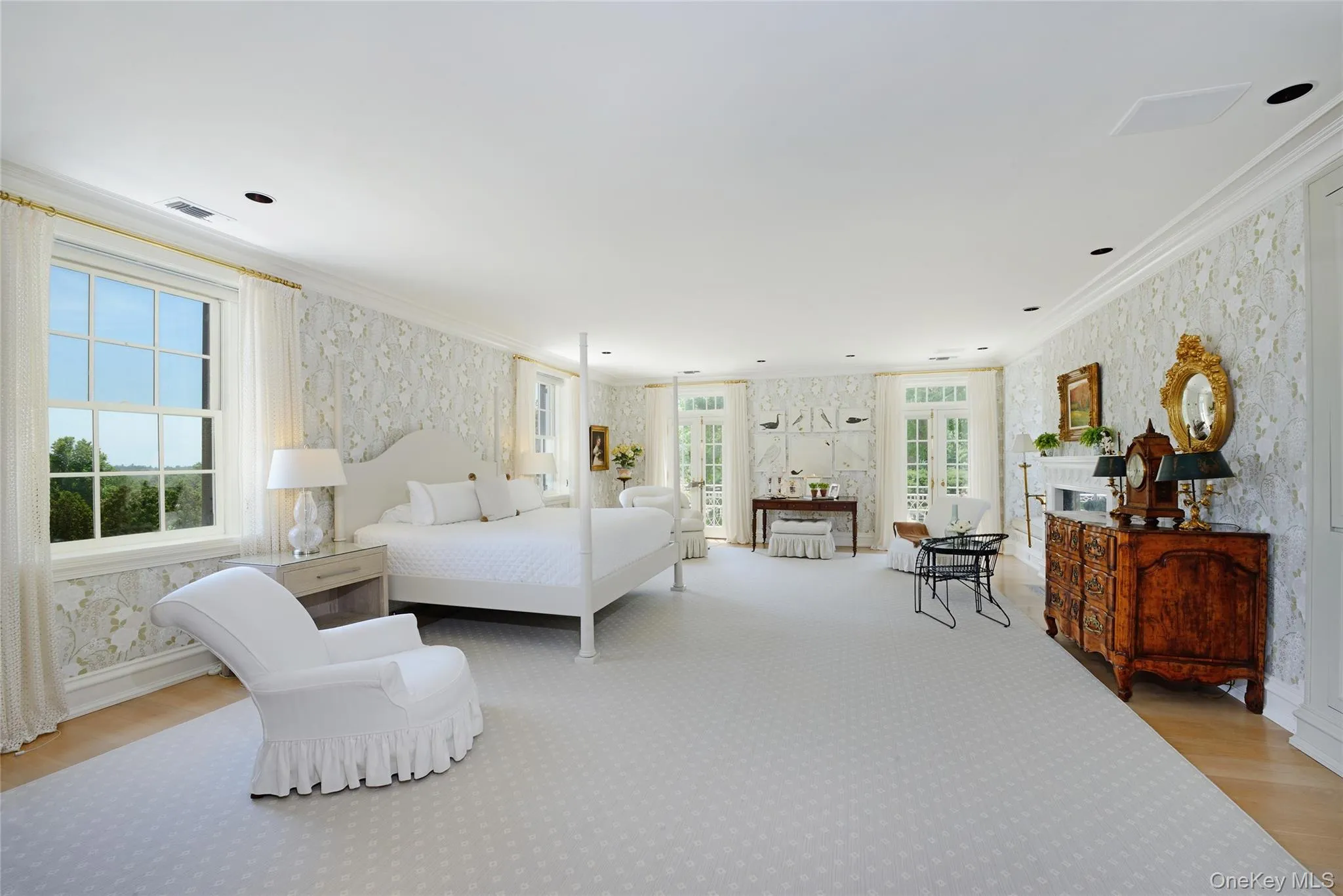 Bedroom with wallpapered walls, light wood-type flooring, ornamental molding, and access to outside Bedroom with wallpapered walls, light wood-type flooring, ornamental molding, and access to outside