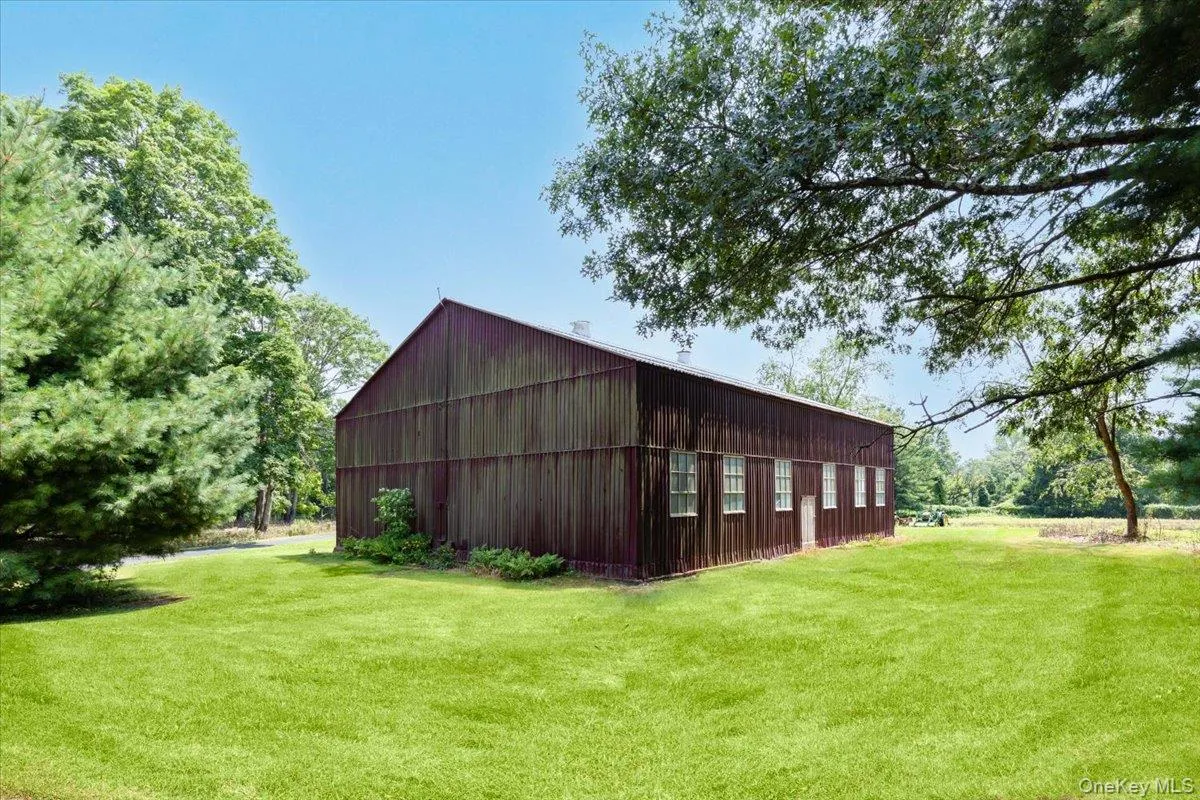 View of pole building with a lawn View of pole building with a lawn