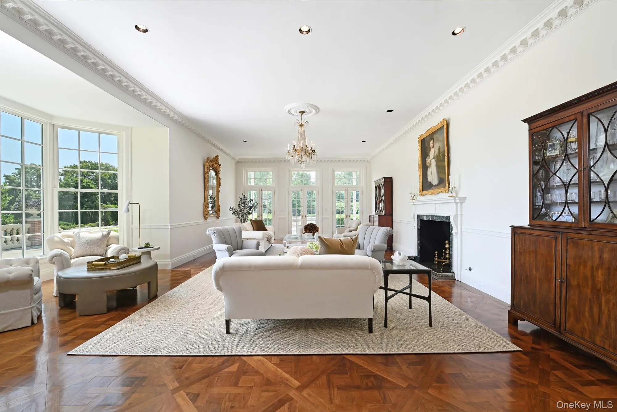 Living area with crown molding, a chandelier, a premium fireplace, and recessed lighting Living area with crown molding, a chandelier, a premium fireplace, and recessed lighting