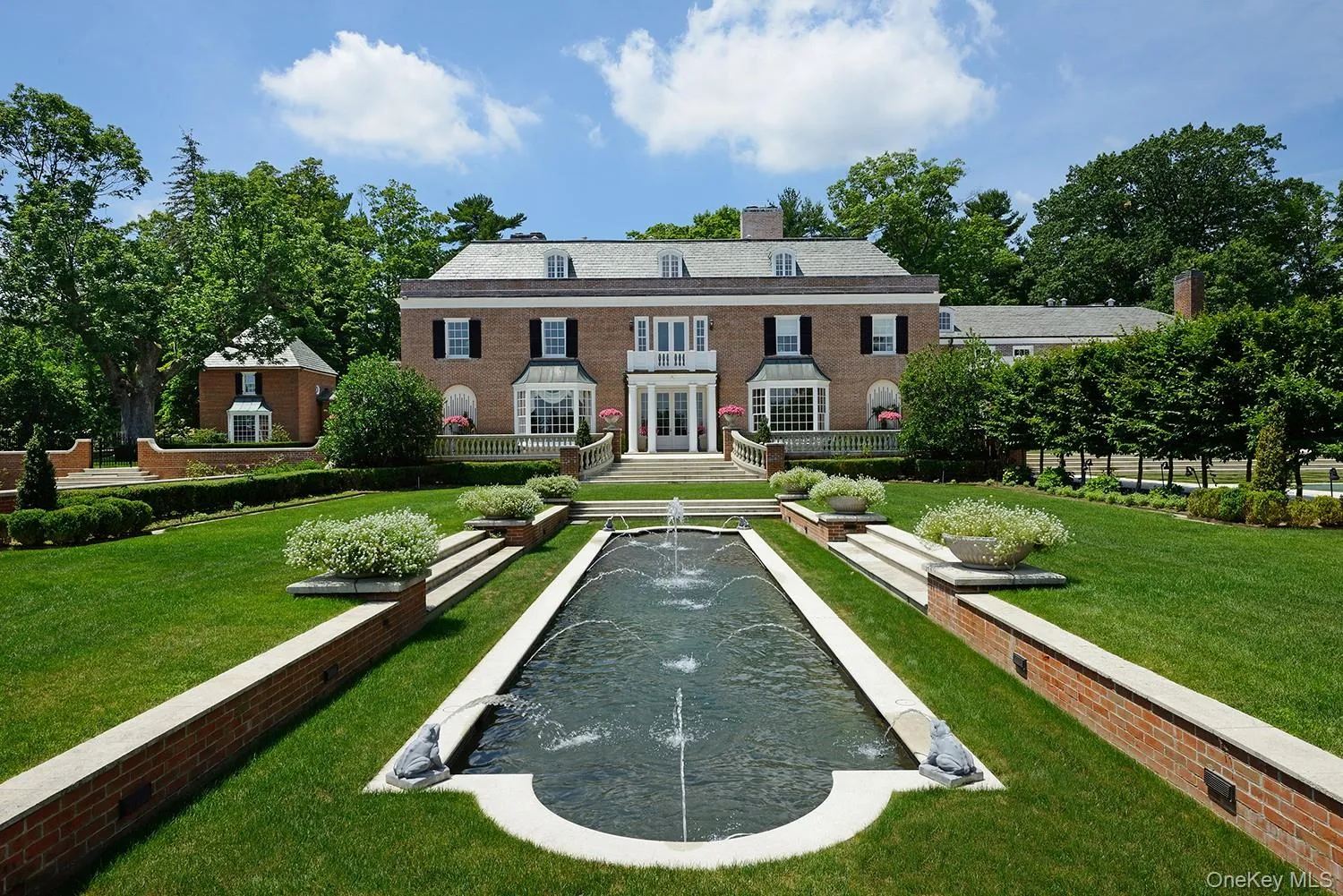 Rear view of property with a chimney, brick siding, and french doors Rear view of property with a chimney, brick siding, and french doors