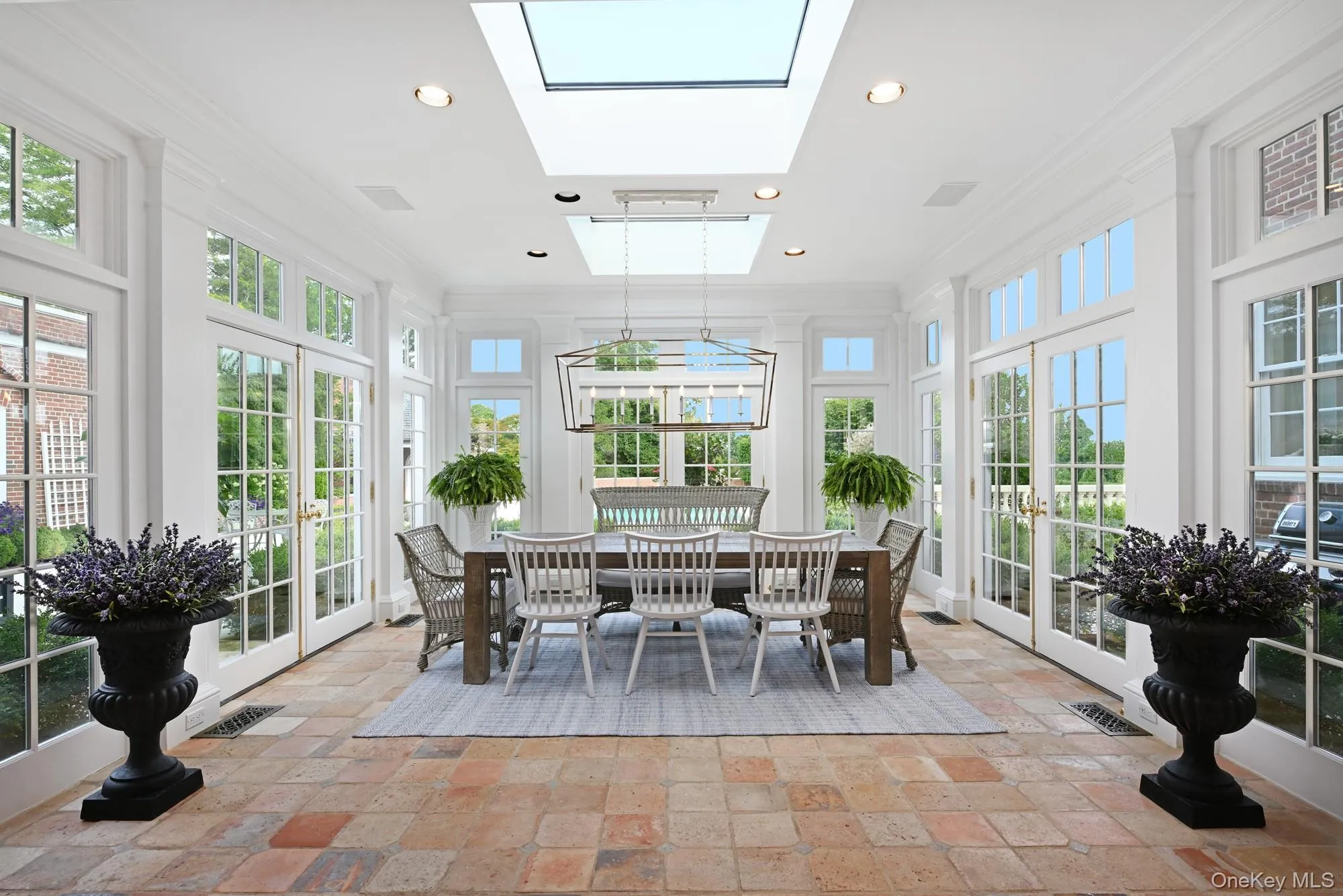 Sunroom / solarium featuring french doors and a skylight Sunroom / solarium featuring french doors and a skylight