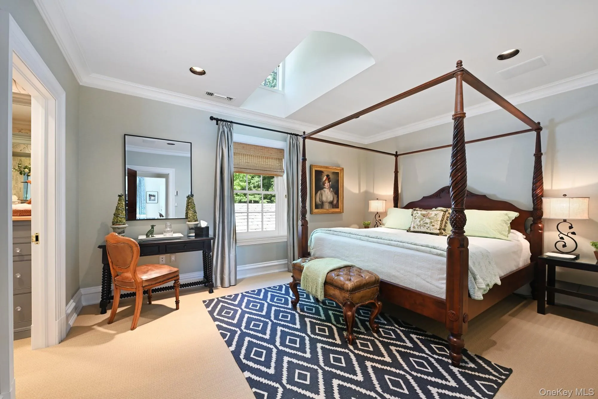 Bedroom with ornamental molding, carpet floors, and a skylight Bedroom with ornamental molding, carpet floors, and a skylight