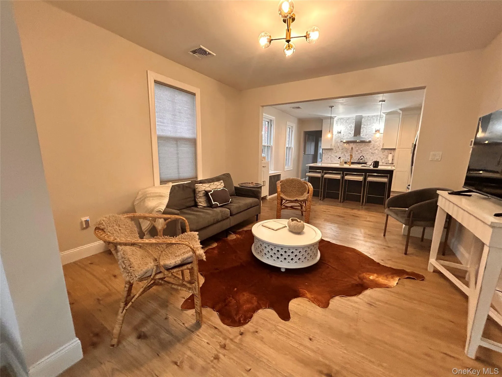 Living area featuring light wood-style floors and baseboards Living area featuring light wood-style floors and baseboards